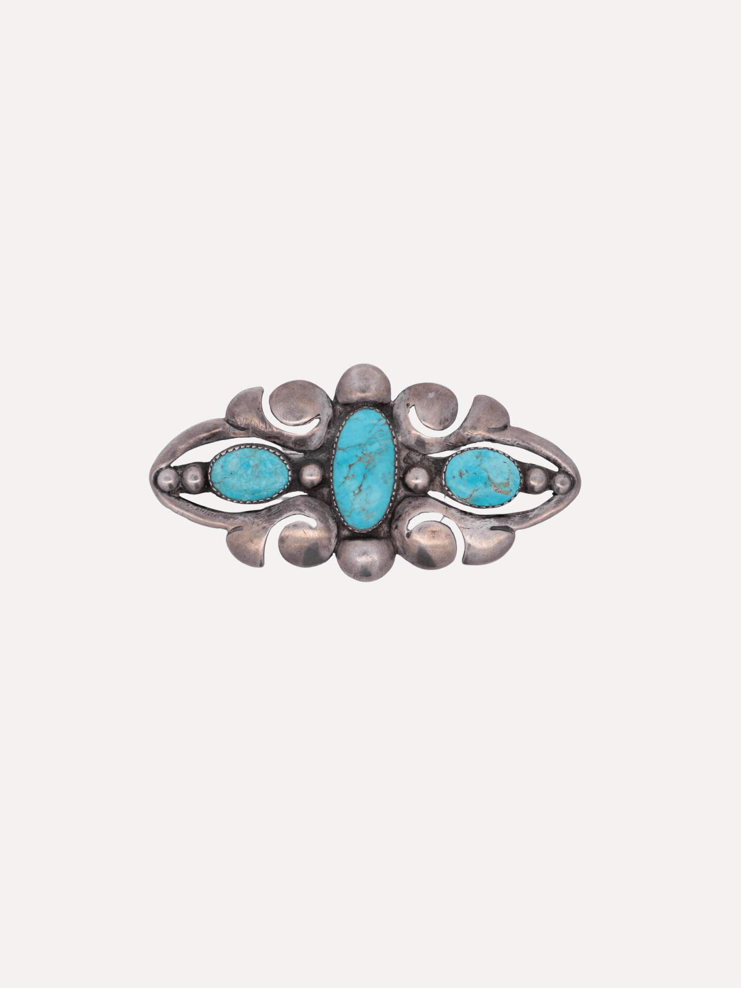 Silver ring with turquoise stones on a white background