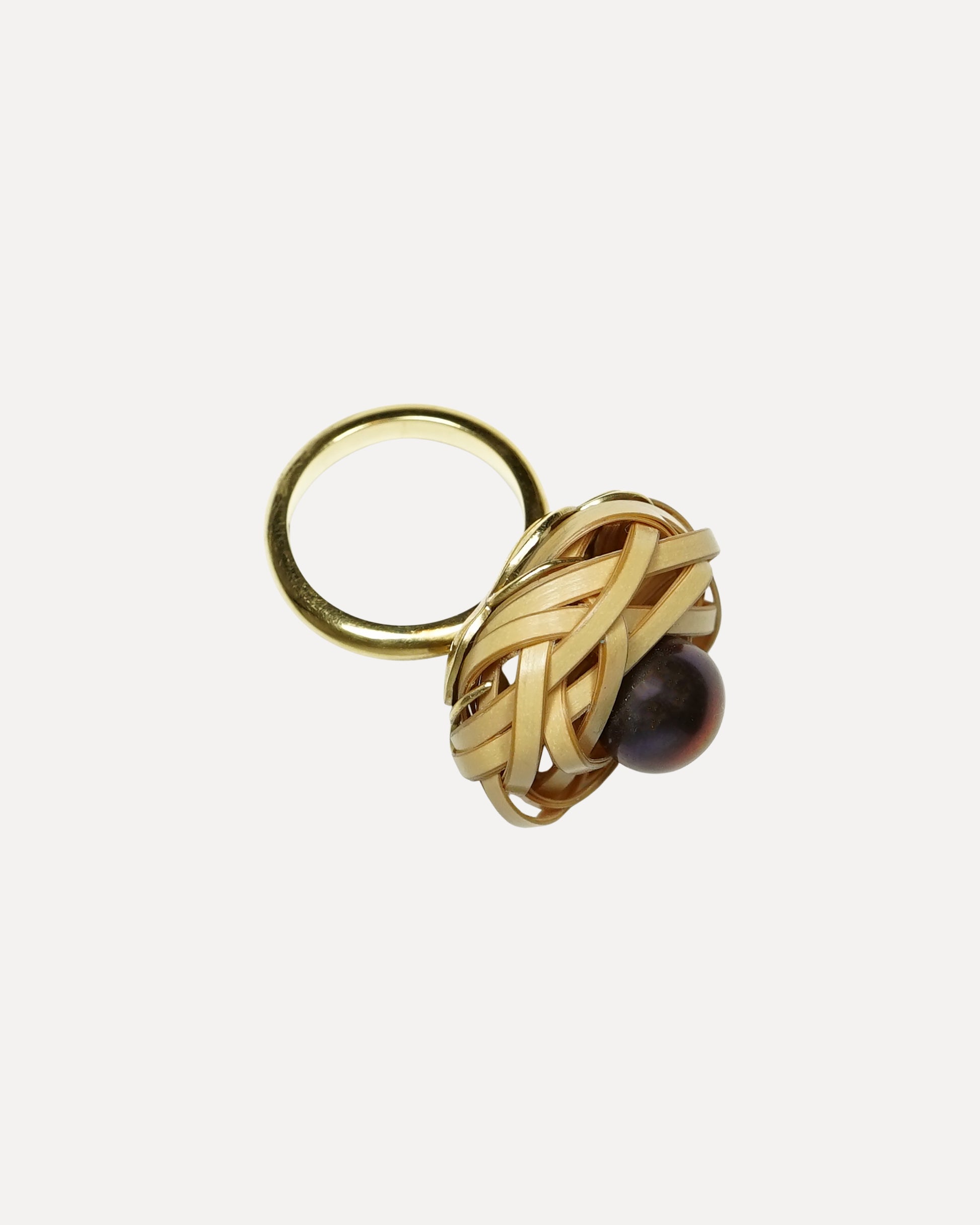 Gold ring with a black pearl on a white background. Bamboo ring with black pearl ring