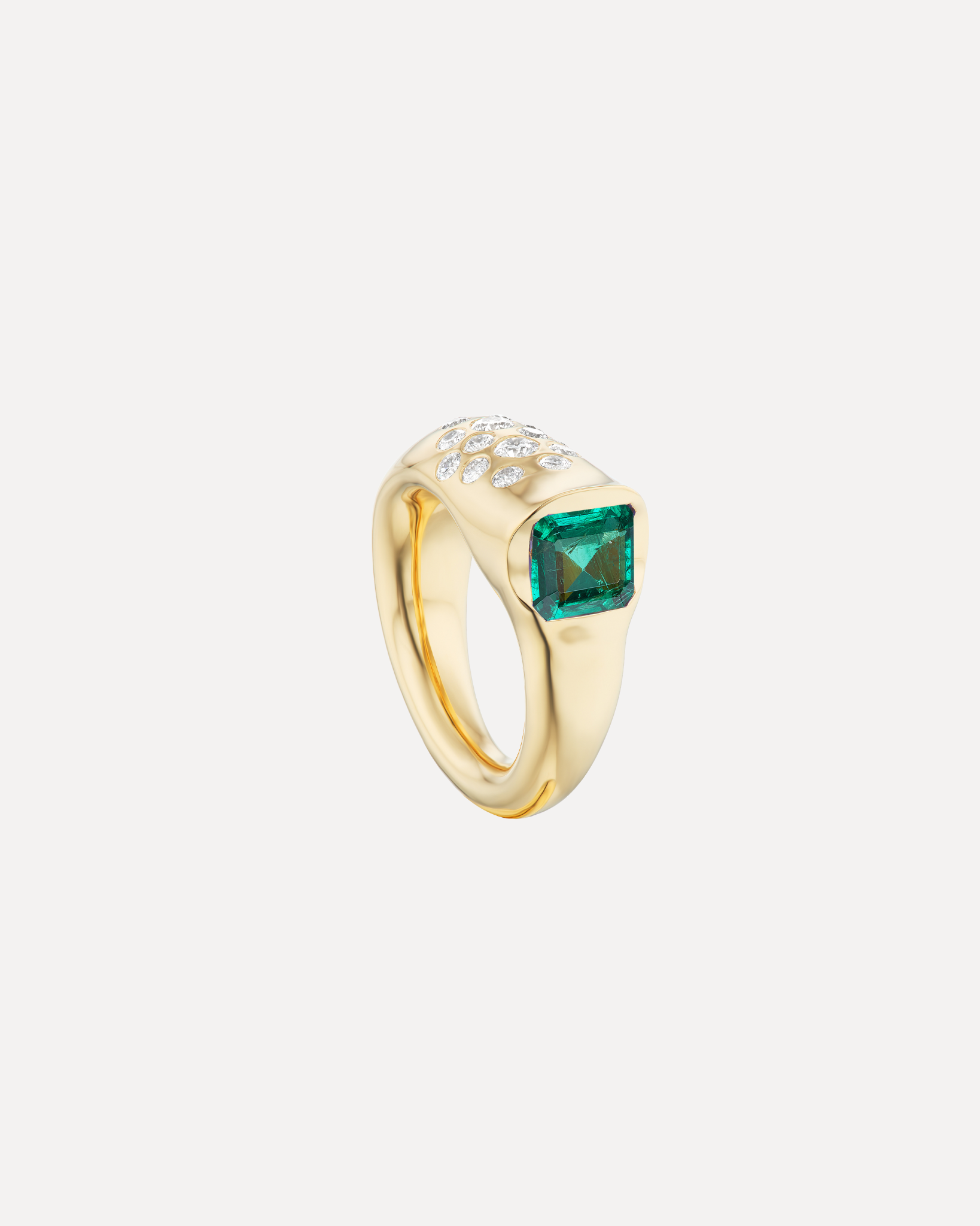 An emerald & diamond battery ring by Uniform Object.