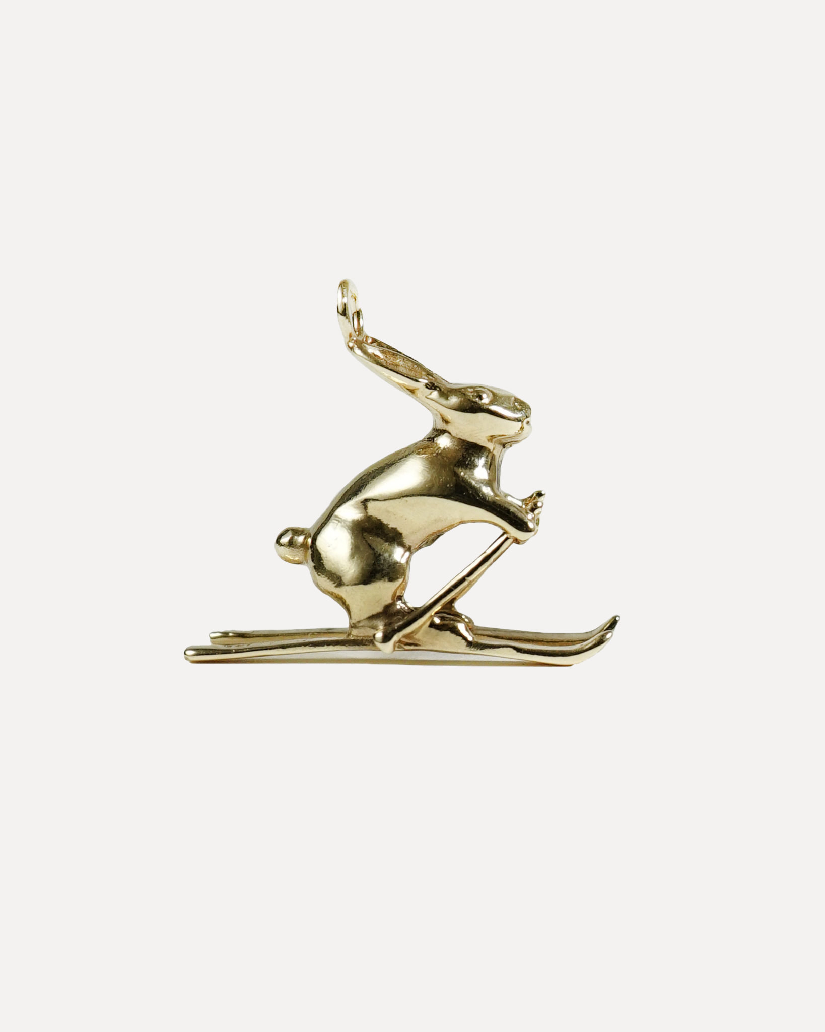 Gold reindeer ornament on a white background