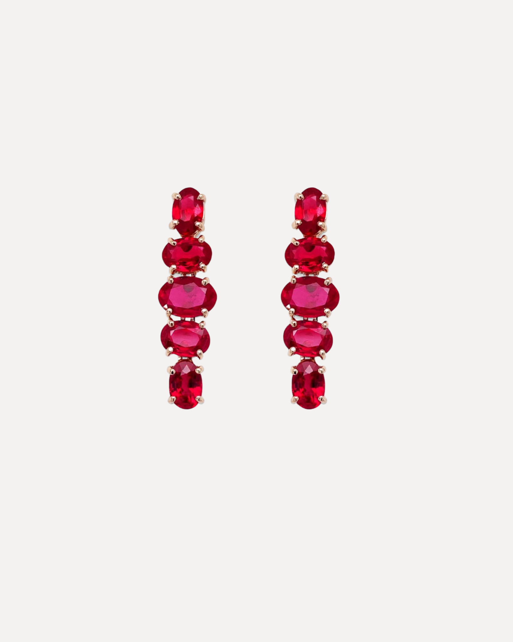 A pair of ruby huggie hoop earrings by Bayco.