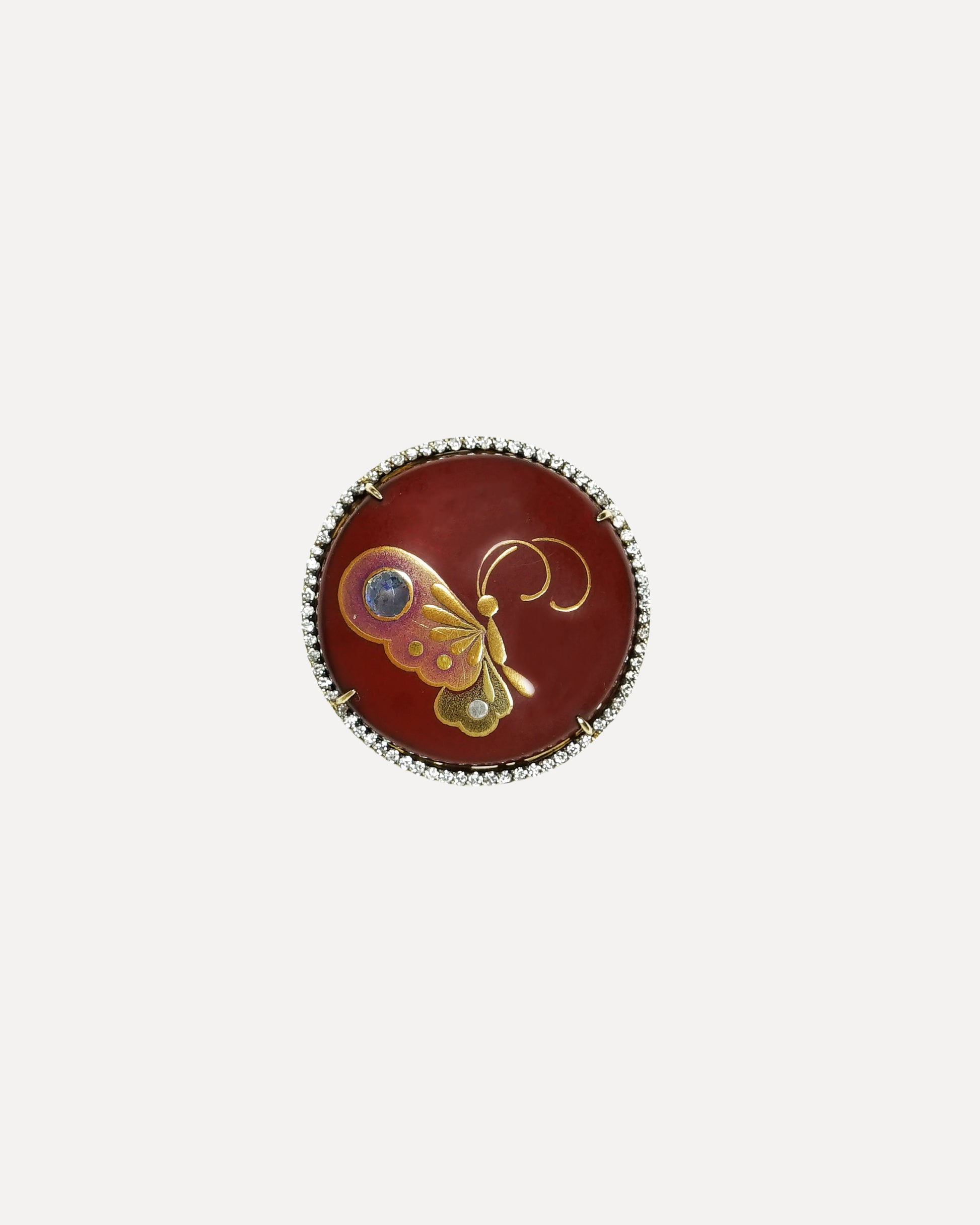 Round decorative item with butterfly design on a white background