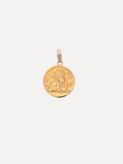 Gold pendant with a face design on a white background