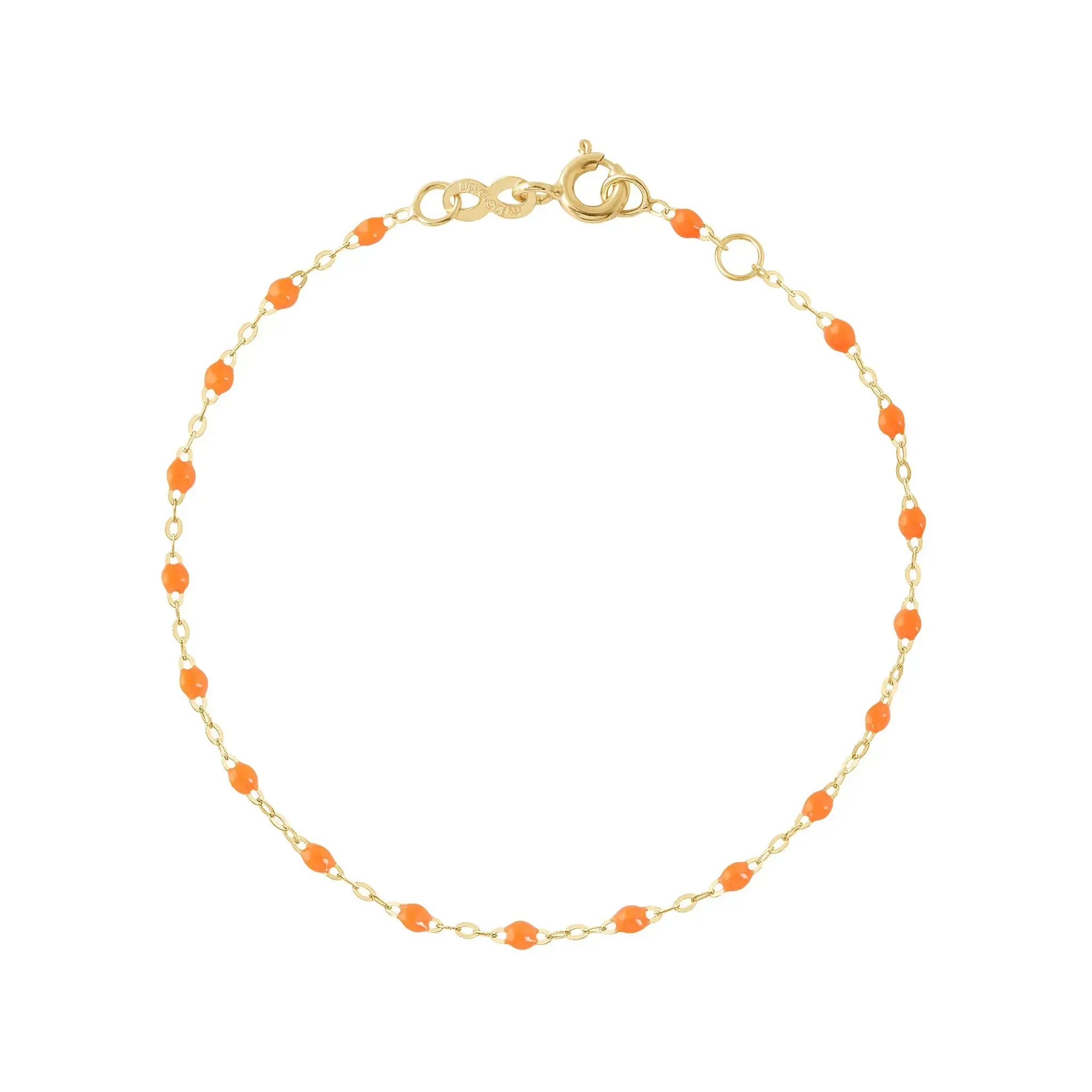 The Classic Gigi bracelet by gigi CLOZEAU features 18K Yellow Gold, and unique Orange jewels for a simple, everyday look.   Each jewel is unique, artisanally made in their family-owned workshop. 18K yellow gold and resin. The bracelet measures 6.7 inches with adjustable clasp at 6.3 inches.