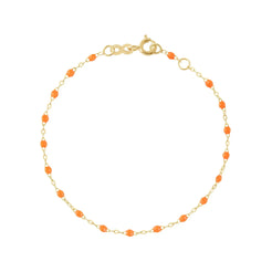 The Classic Gigi bracelet by gigi CLOZEAU features 18K Yellow Gold, and unique Orange jewels for a simple, everyday look.   Each jewel is unique, artisanally made in their family-owned workshop. 18K yellow gold and resin. The bracelet measures 6.7 inches with adjustable clasp at 6.3 inches.