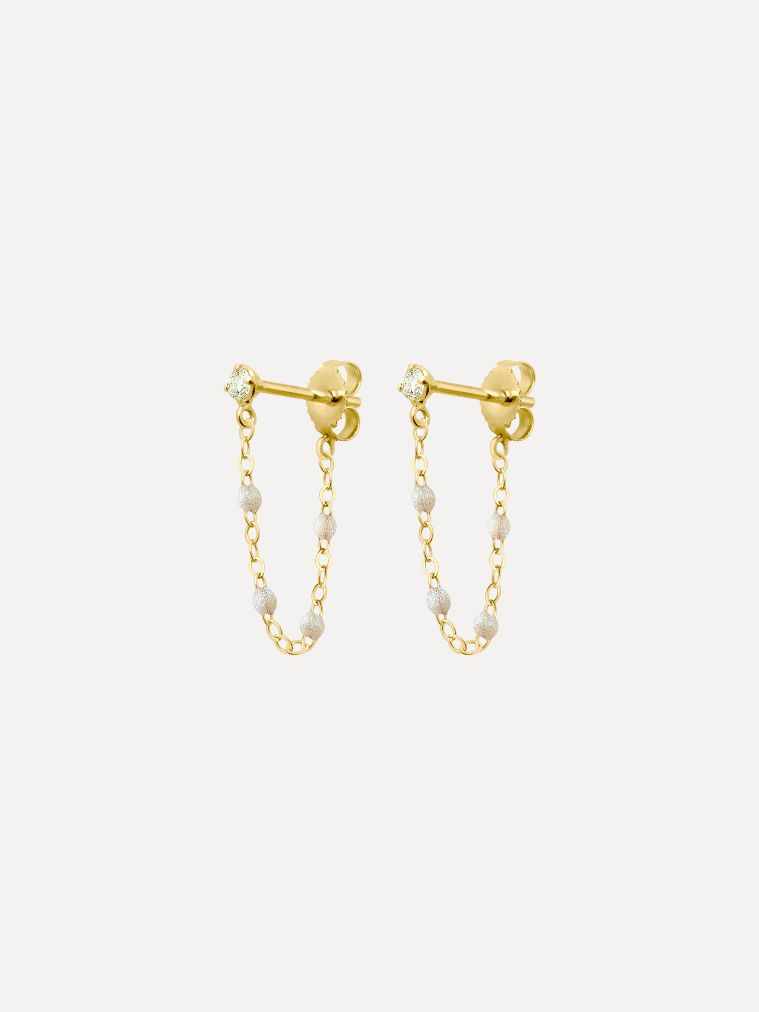 Gold chain earrings with small beads on a white background