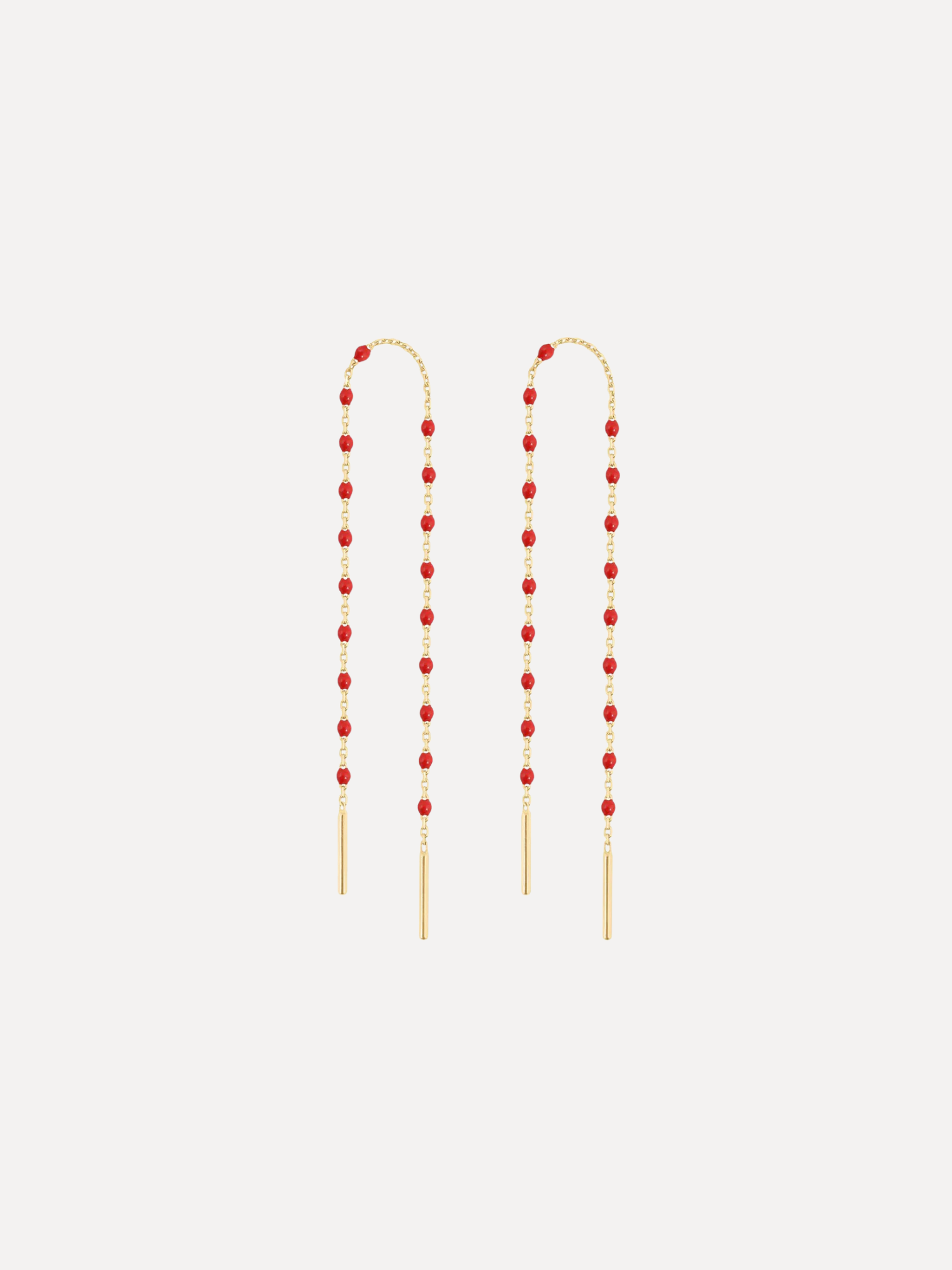 Pair of red beaded earrings on a white background