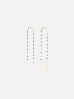 Pair of beaded earrings with gold and turquoise beads on a white background
