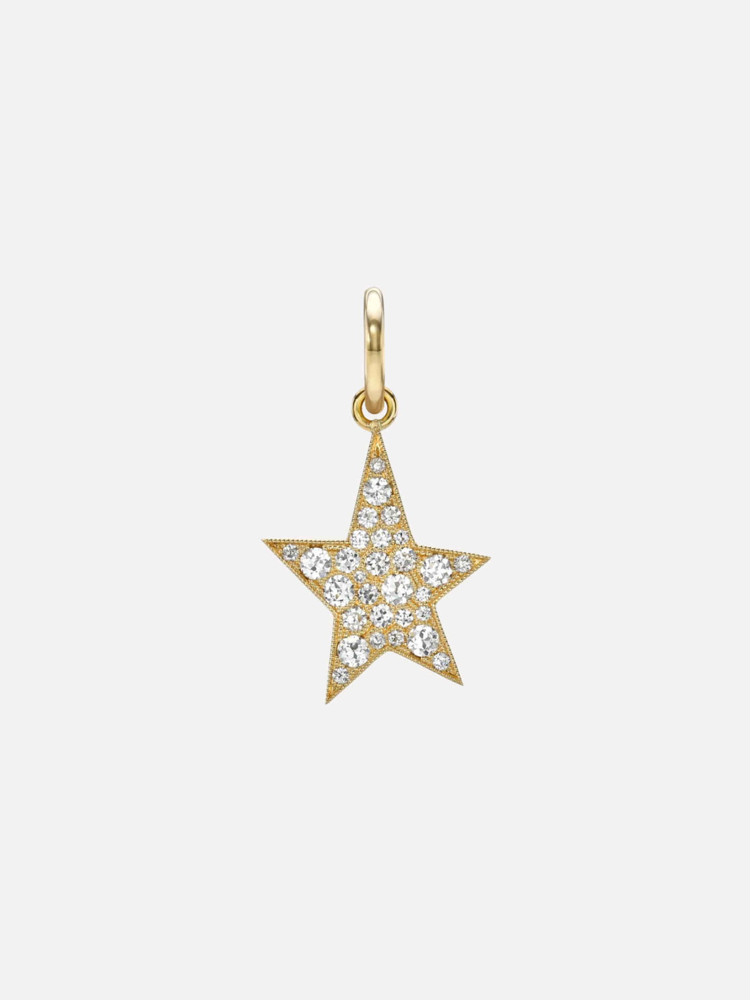 A gold star-shaped pendant charm paved with small clear stones, shown against a plain light gray background.