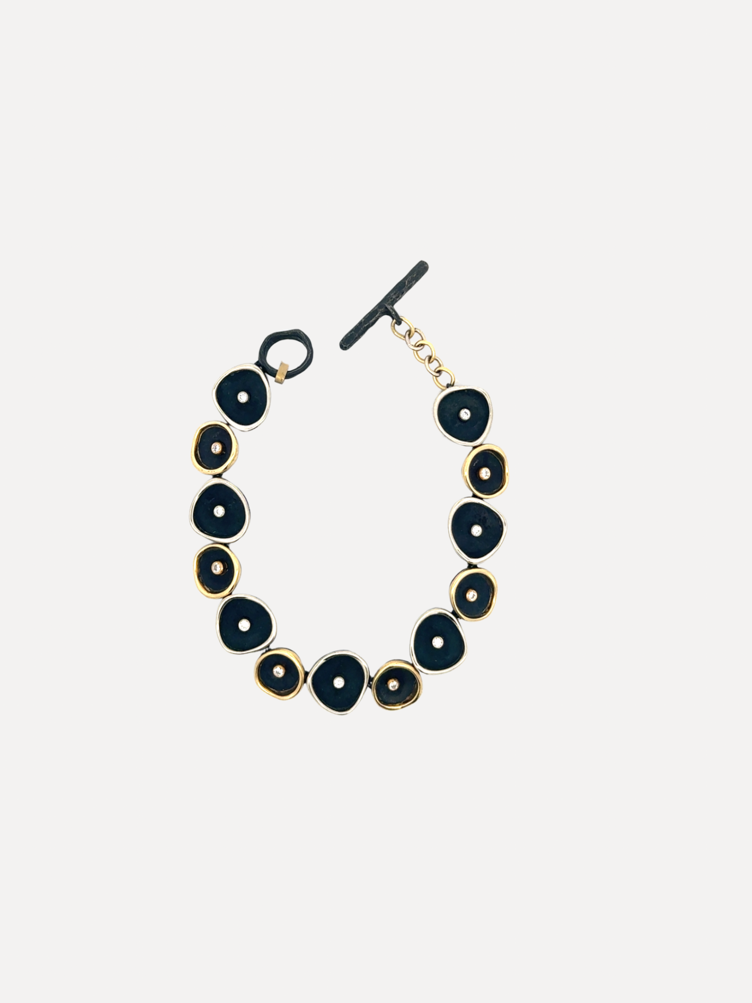 Black and gold bracelet on a light gray background