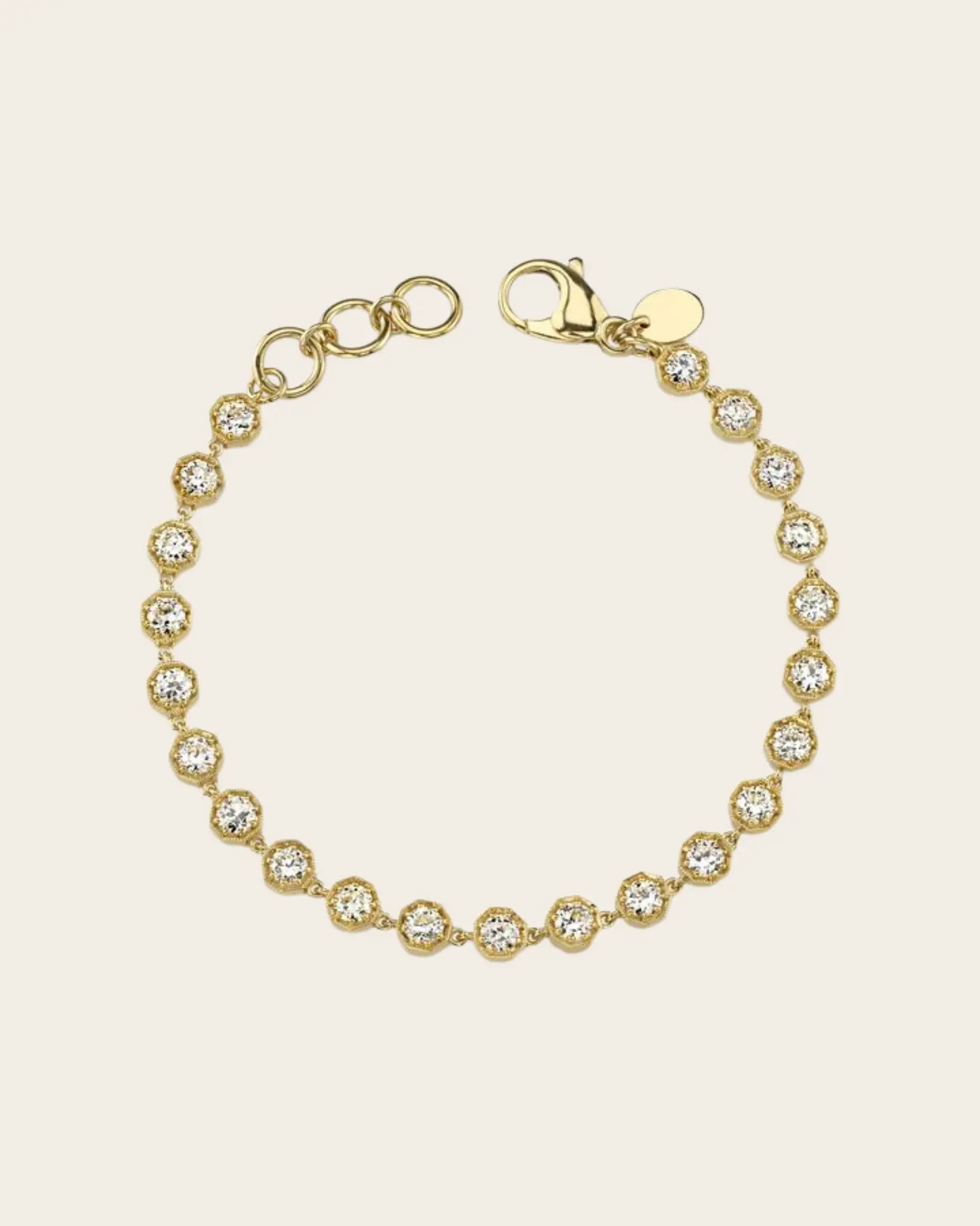 A gold diamond tennis bracelet by Single Stone.