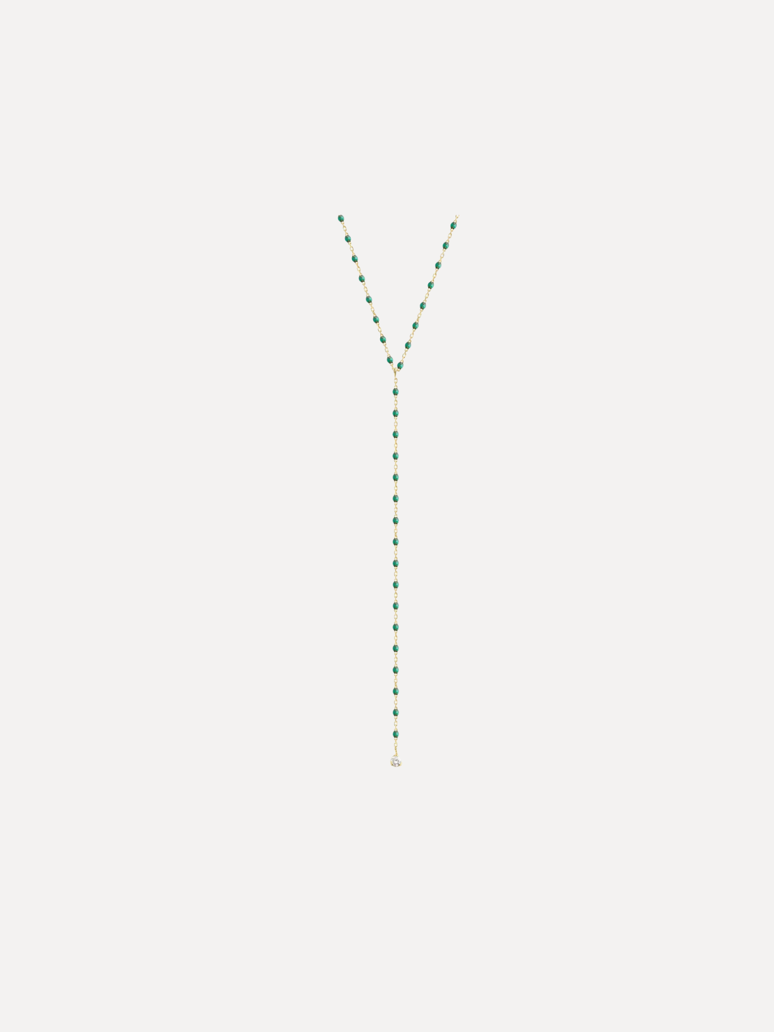 Green beaded necklace on a white background
