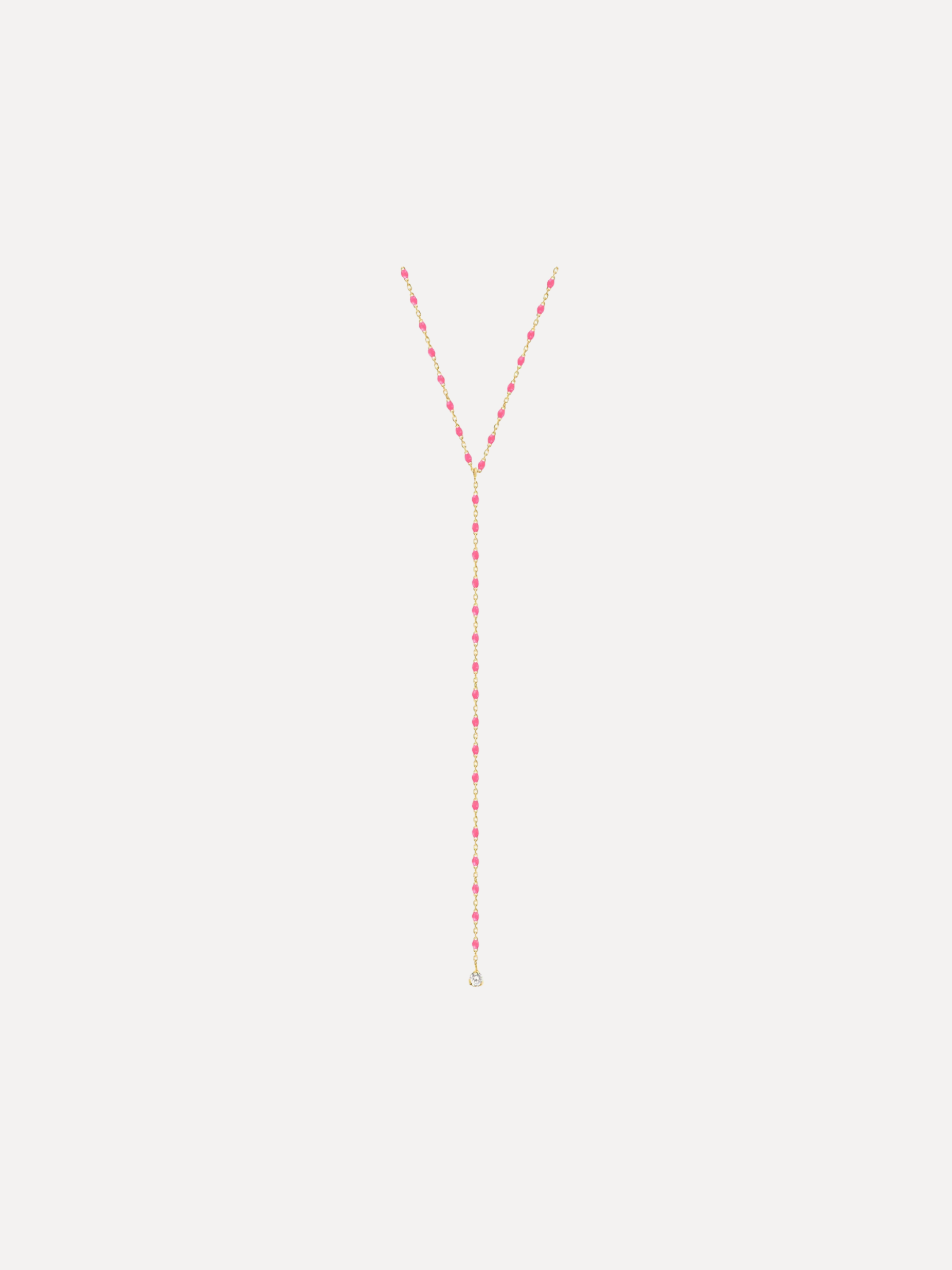 Long necklace with red beads on a white background