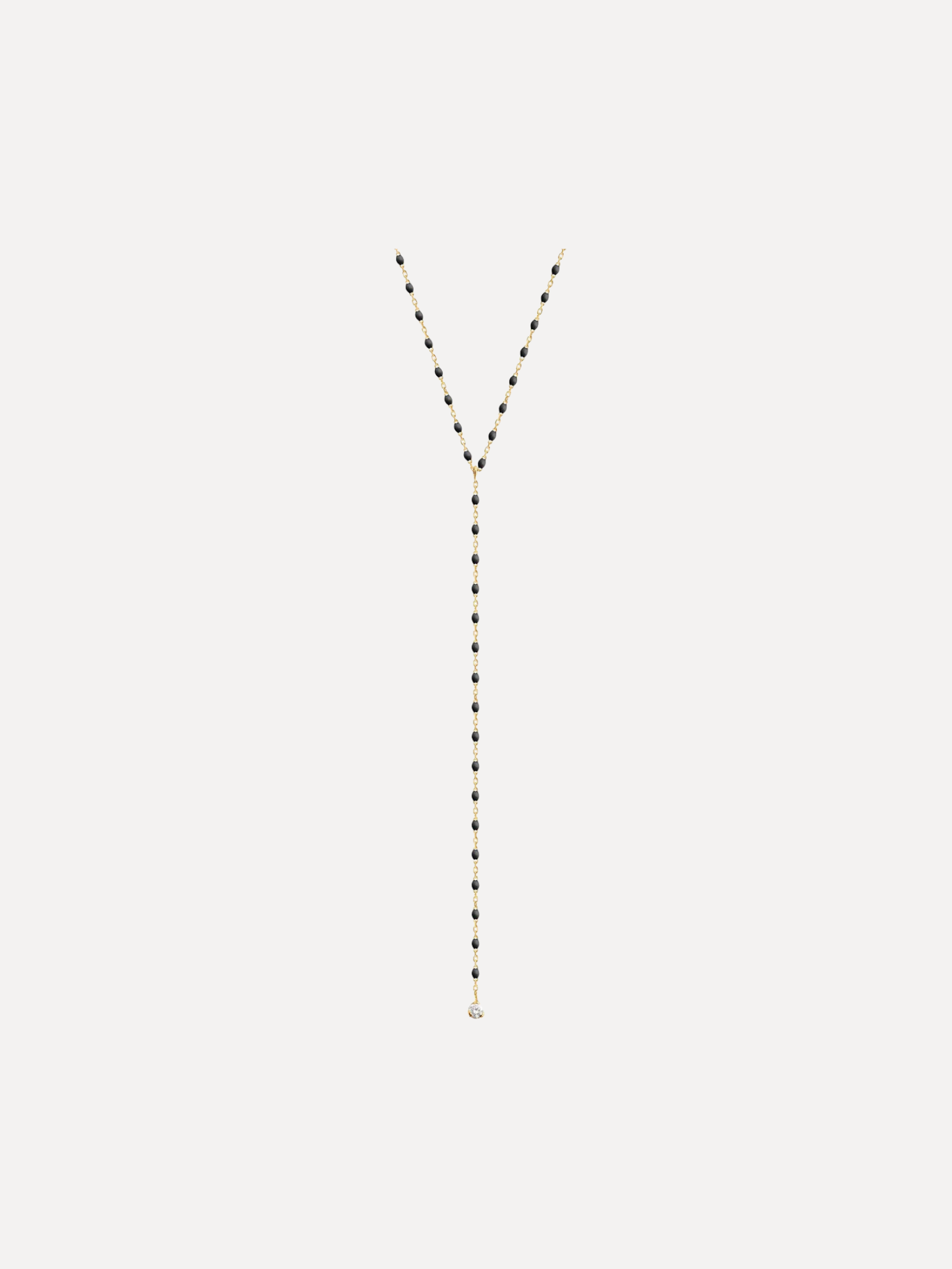 Long necklace with black and gold beads on a white background
