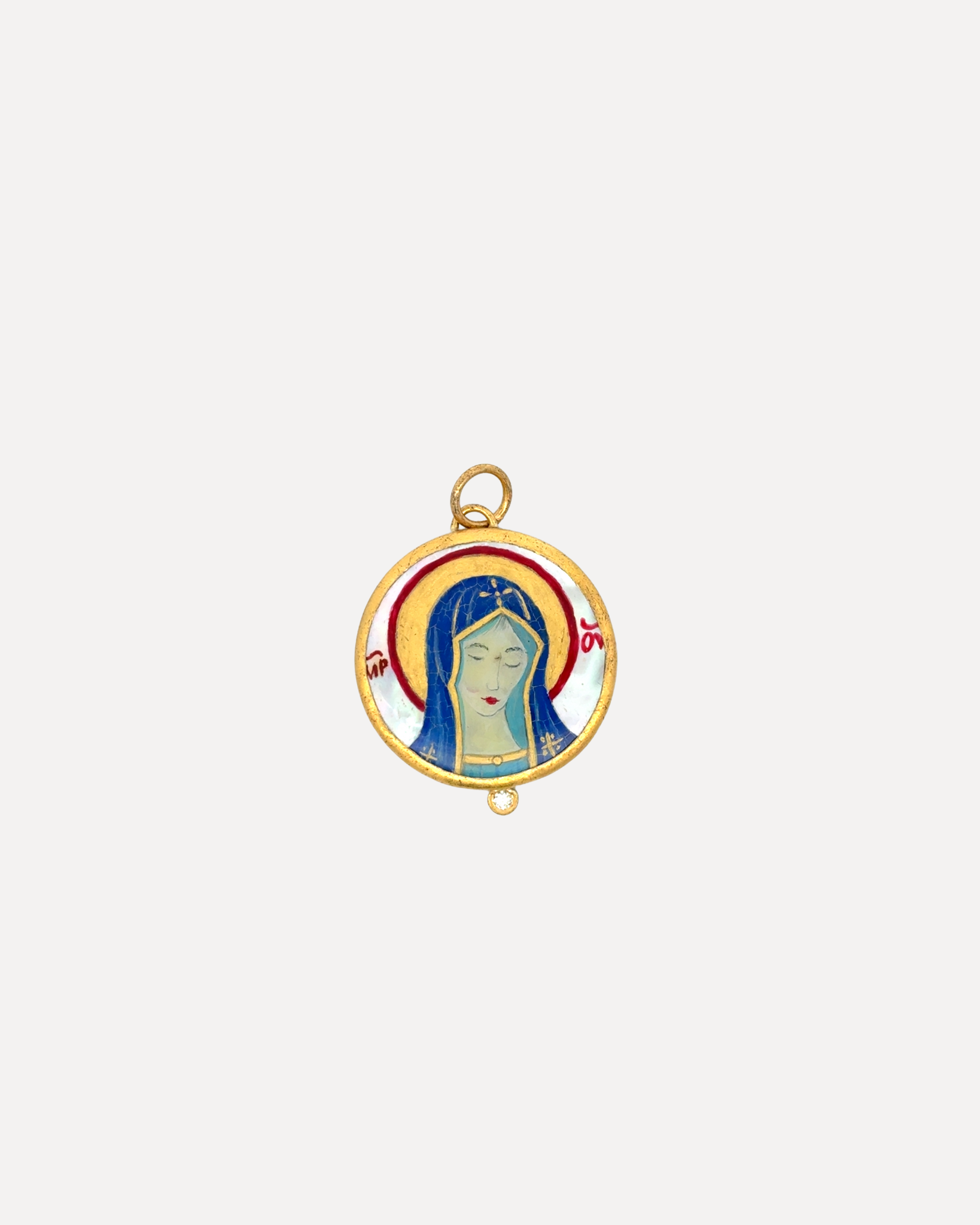 A gold hand painted mini Madonna pendant by Prehistoric Works.