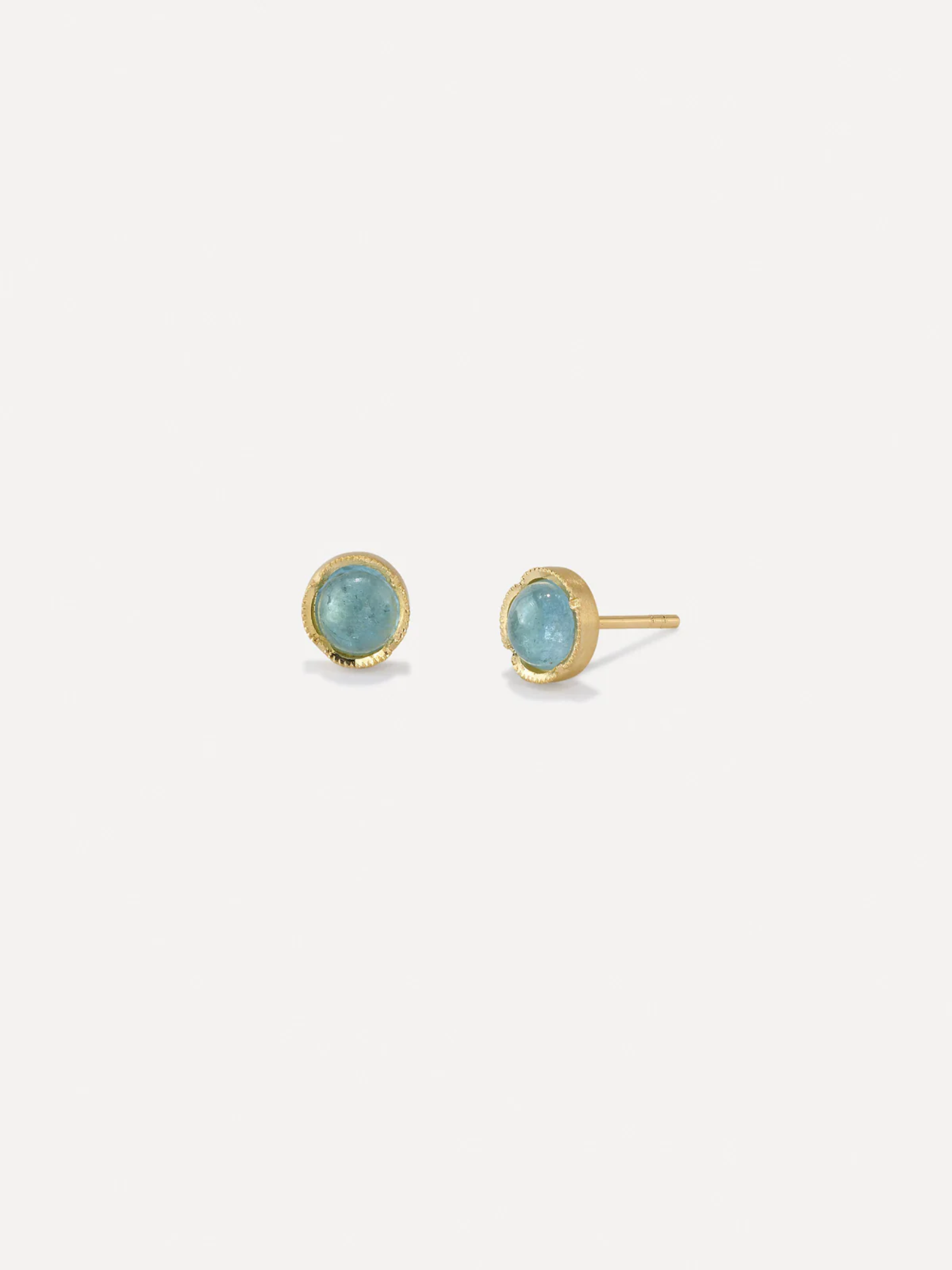 Gold and diamond earrings on a white background