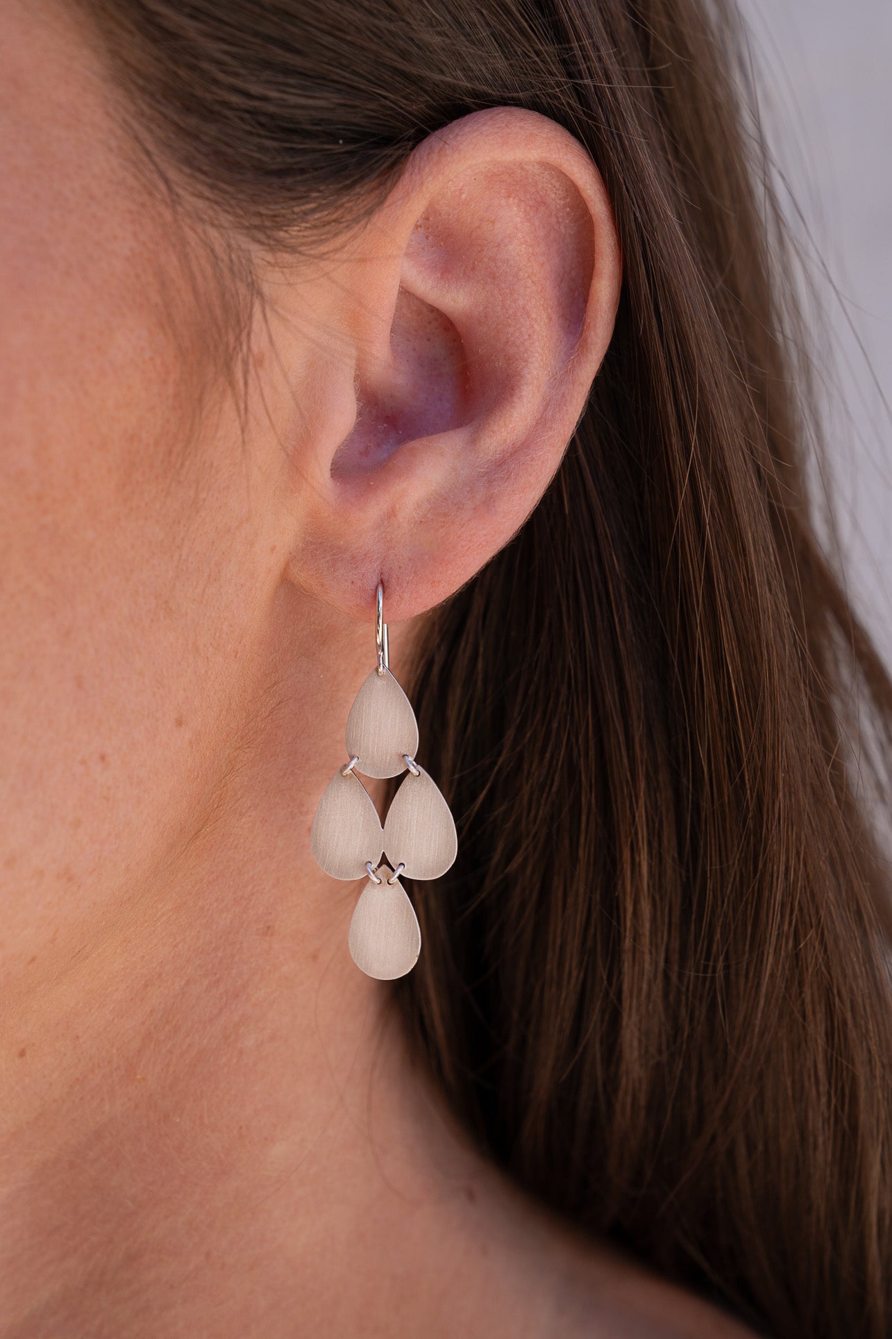 Irene Neuwirth flat white gold ear rings on a fish hook