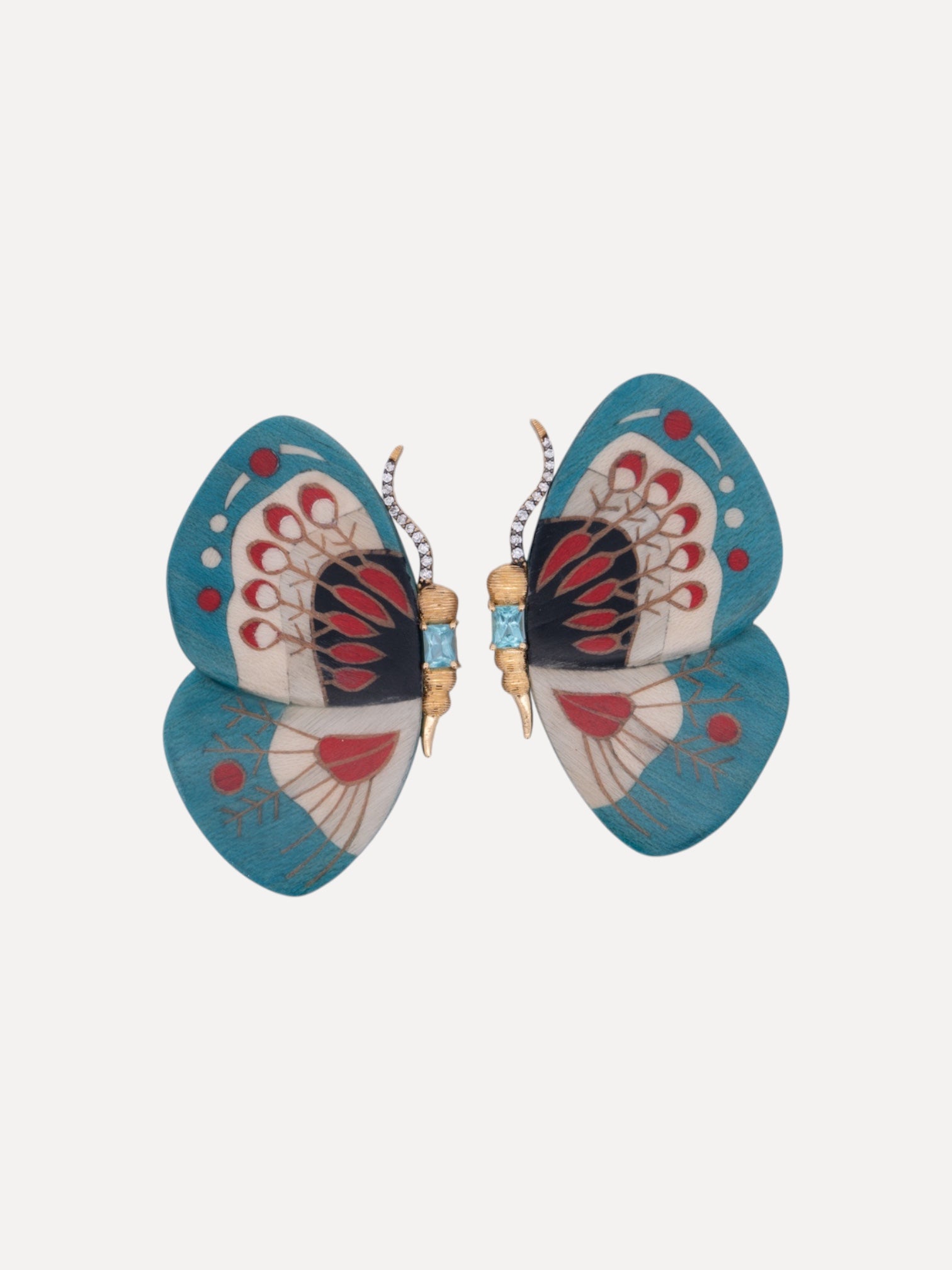 Butterfly-shaped earrings with blue wings and red accents on a white background