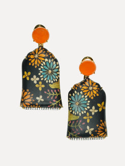 Floral patterned earrings with orange tops on a white background. Marquetry earrings with orange sapphire and carnelian