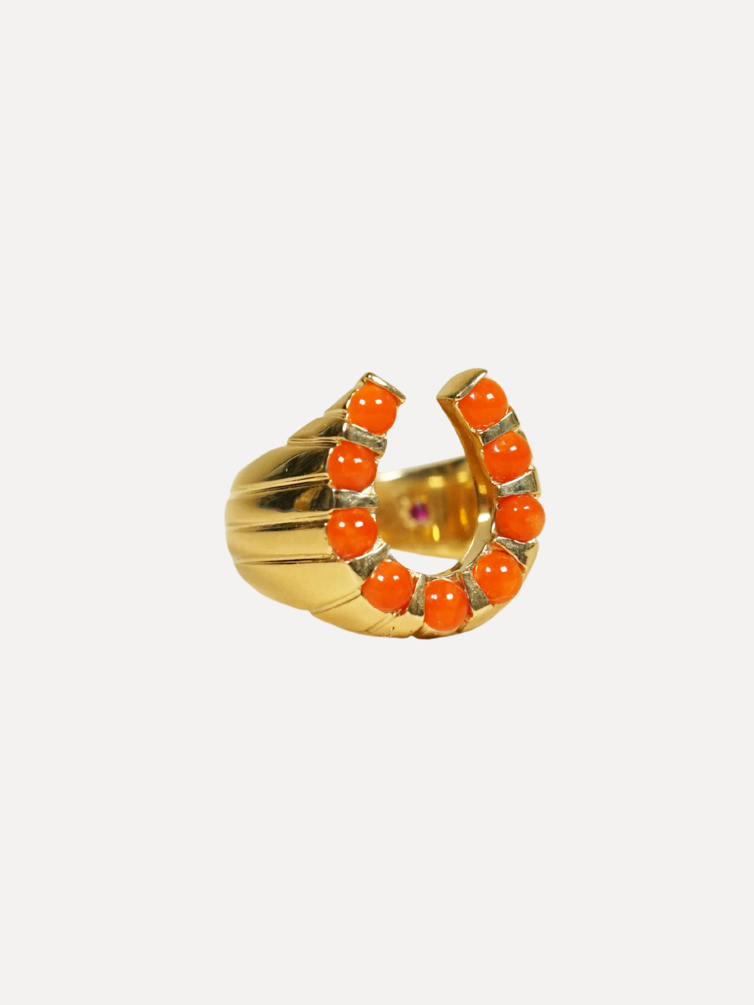 Gold earring with orange gemstones on a white background