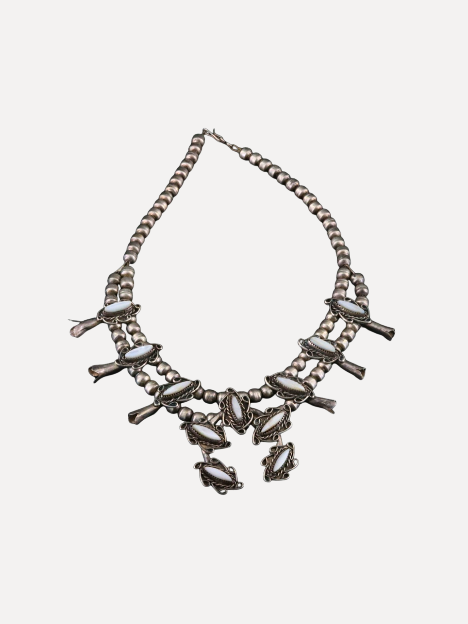 Necklace with multiple strands and decorative elements on a white background