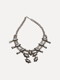 Necklace with multiple strands and decorative elements on a white background
