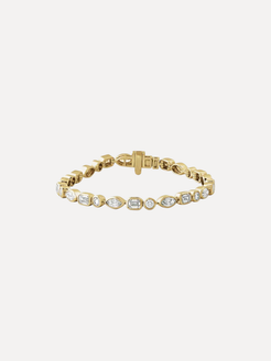 Gold bracelet with clear stones on a light beige background