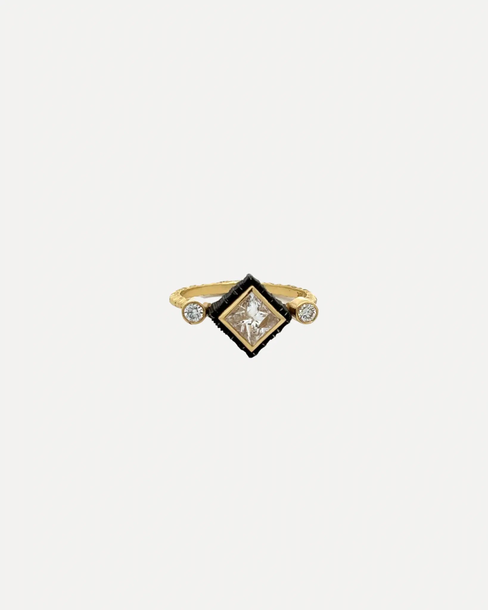 An 18k yellow gold princess cut diamond ring by Sarah Graham.