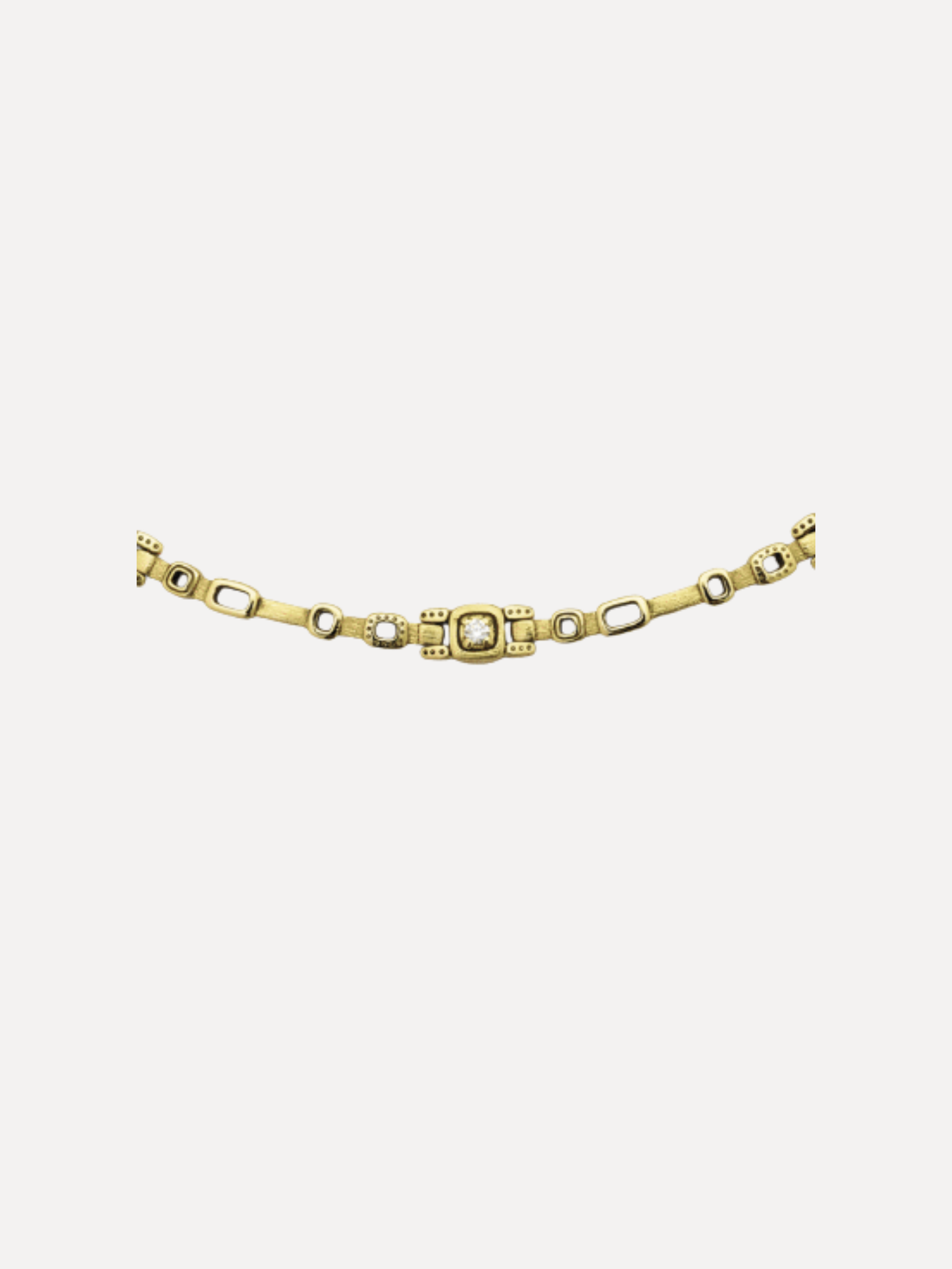 Alex Sepkus A gold-toned chain bracelet featuring a central rectangular link with a textured, diamond-like pattern, flanked by alternating elongated oval links and smaller round links, shown against a plain light gray background.