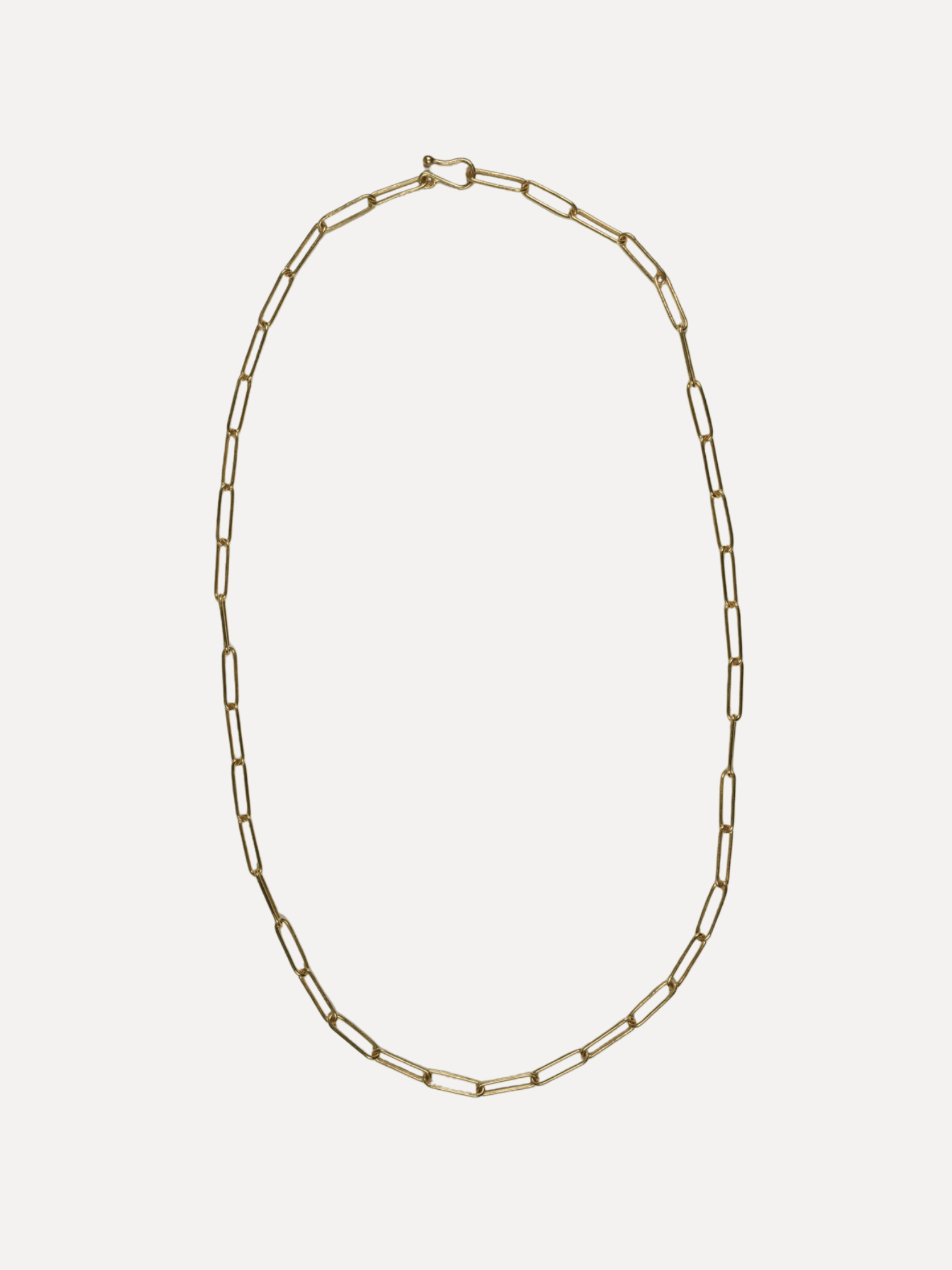 Gold chain necklace on a white background