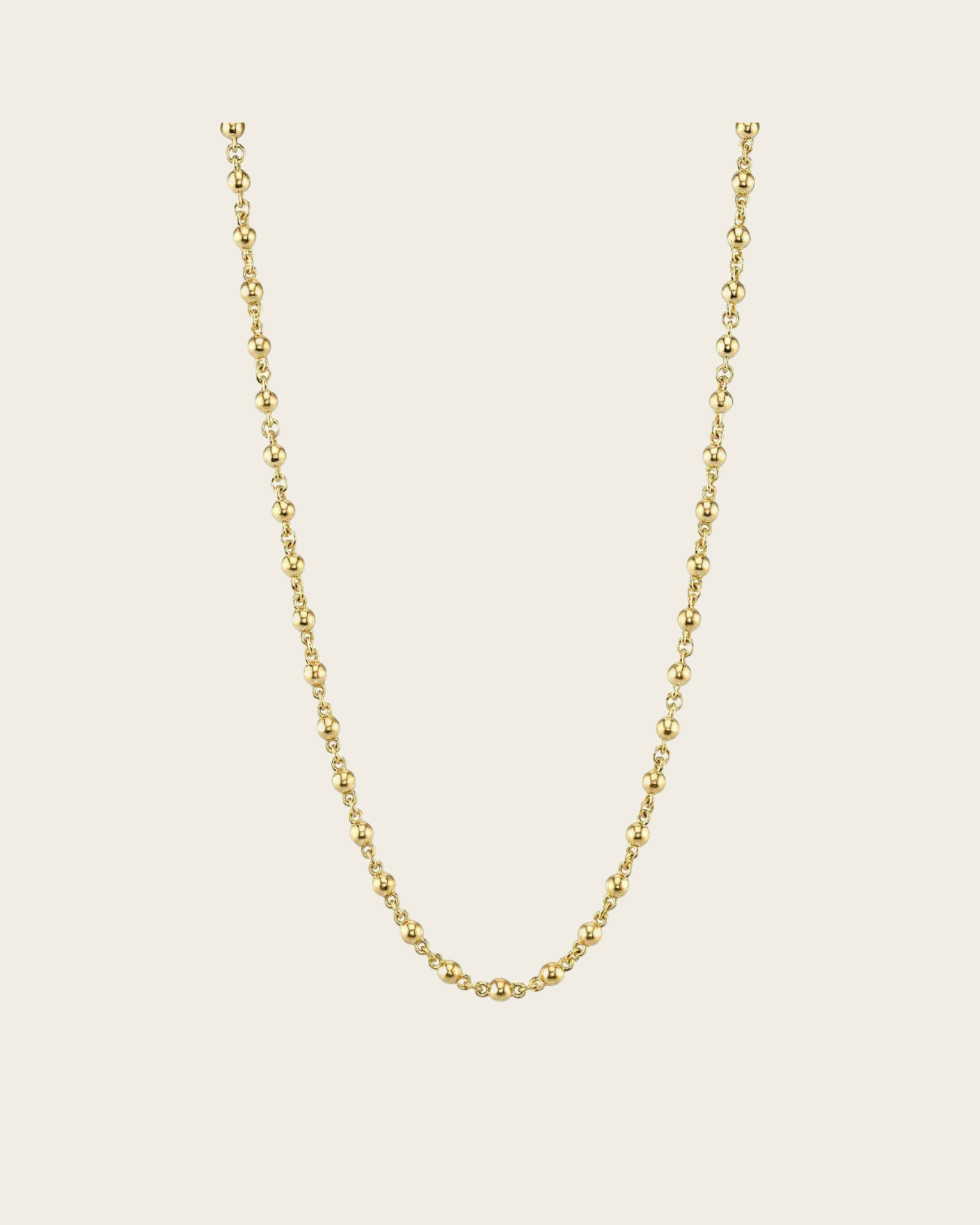 A gold round ball rosary chain by Single Stone.