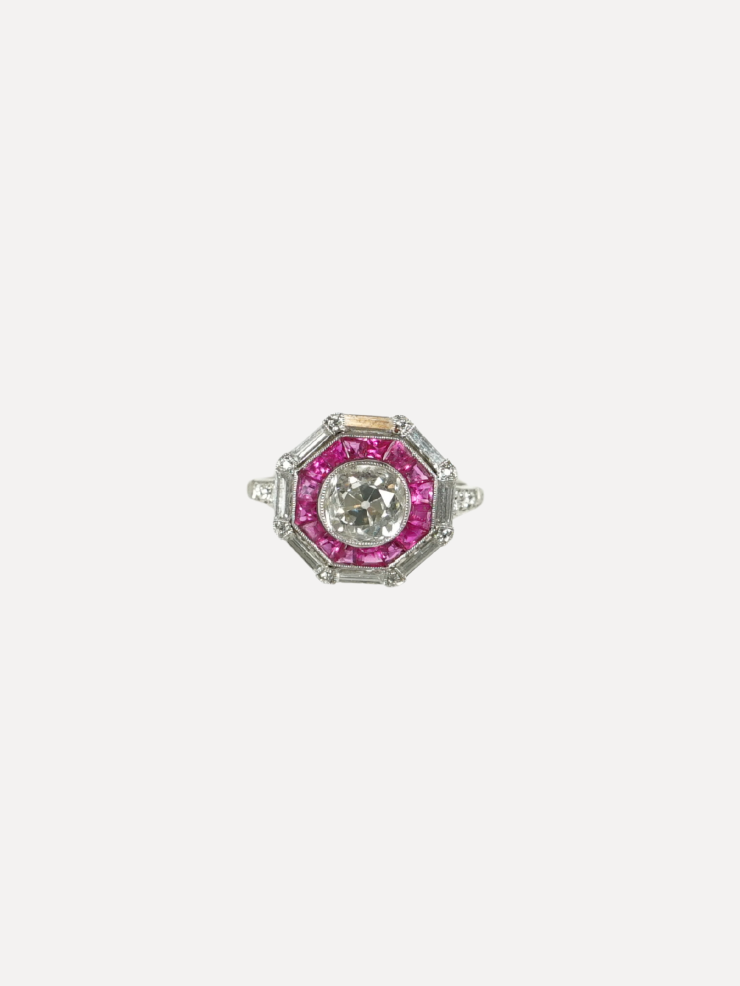 Diamond ring with pink gemstones on a white background