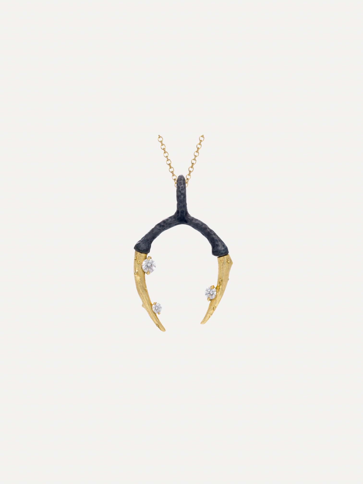Gold and black pendant necklace on a white background