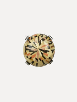 Decorative round object with geometric pattern on a white background