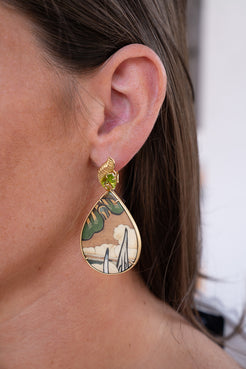 Teardrop-shaped earring with green gemstone worn by a person. Silvia_Furmanoich_Marquetry_Earrings