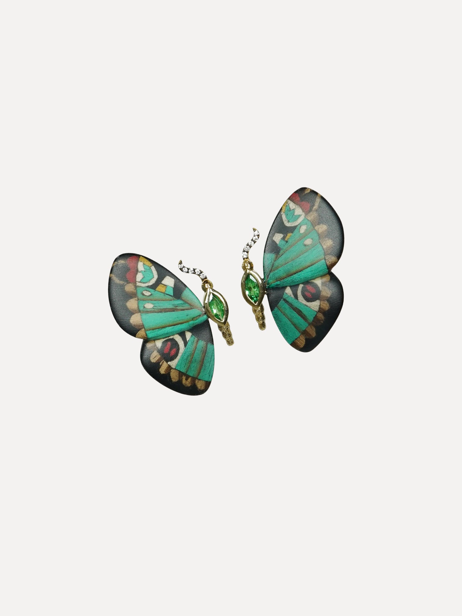 Butterfly-shaped earrings with green and gold design on a white background