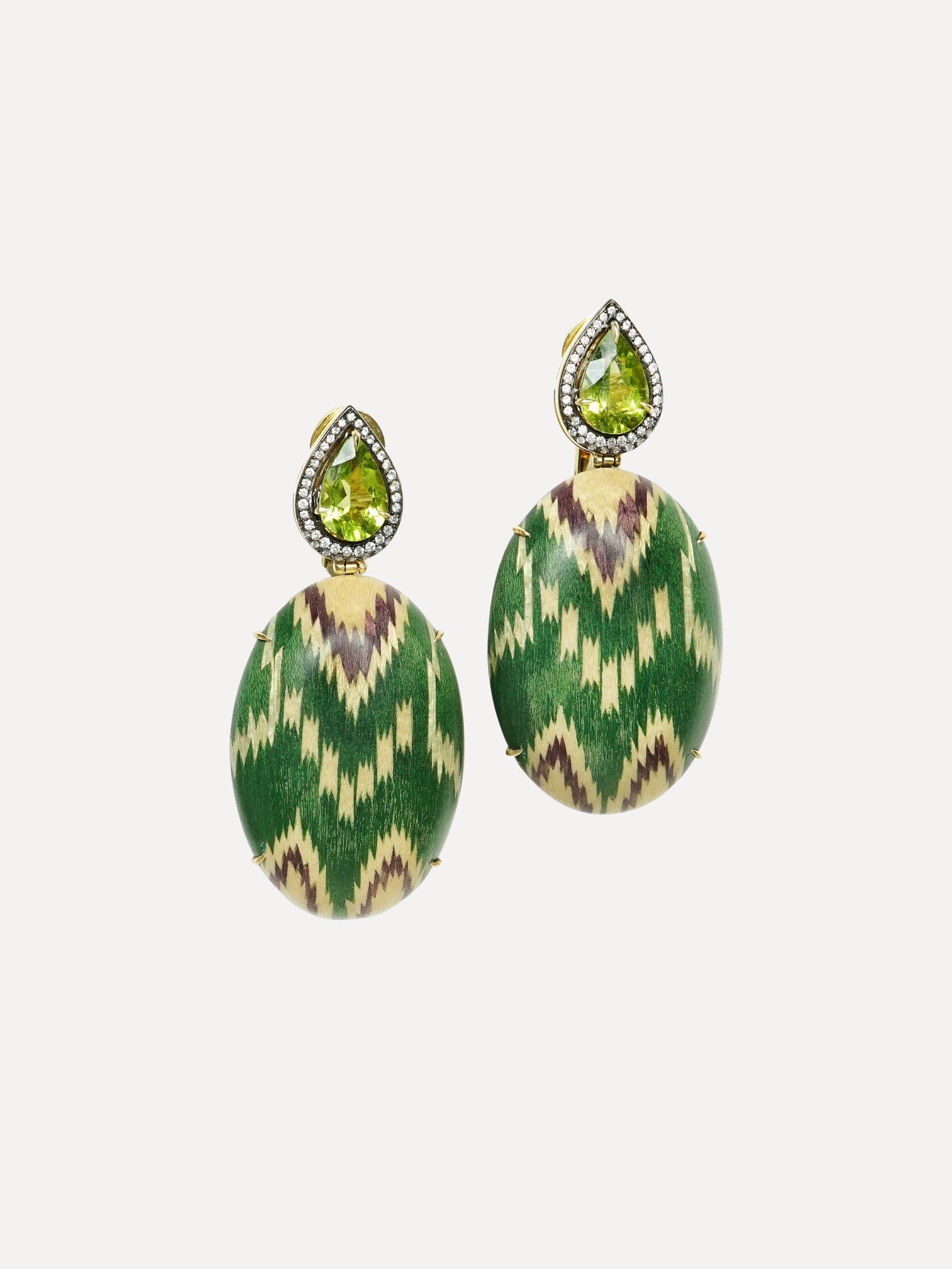 Pair of green and gold earrings with teardrop-shaped gemstones on a white background