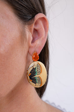 Close-up of a person wearing butterfly-themed earrings with a white background. Silvia_Furmanovich_Mexican_Opal_and_Marquestry_Butterfly_Earrings