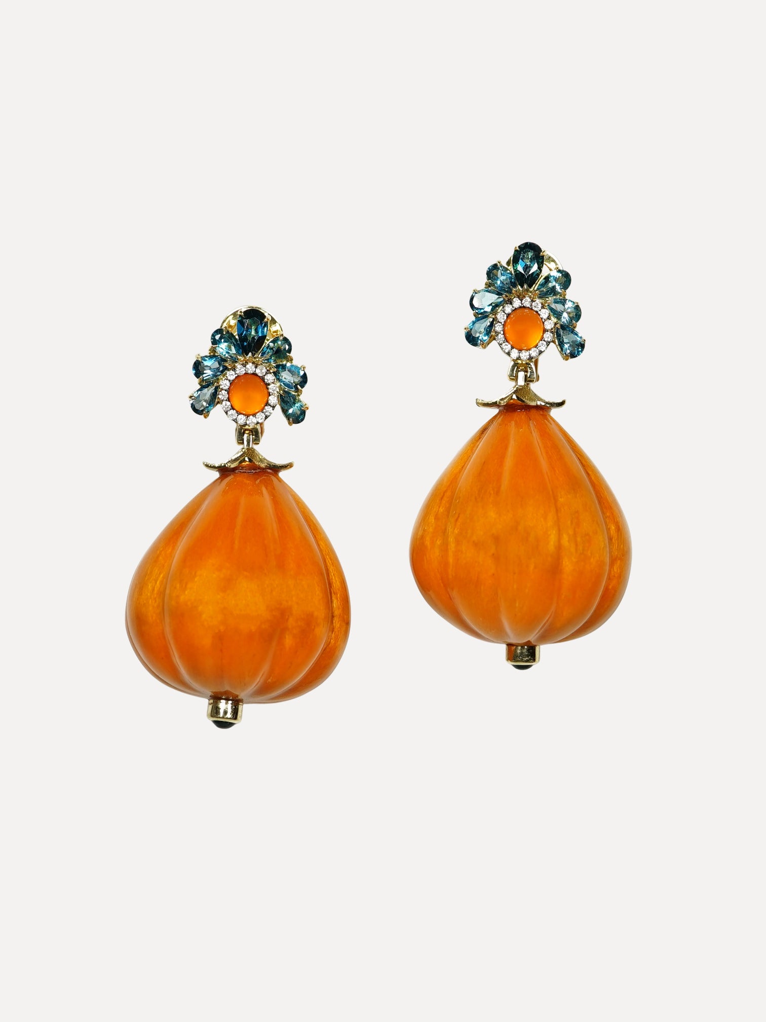Pair of orange earrings with gemstone accents on a light gray background