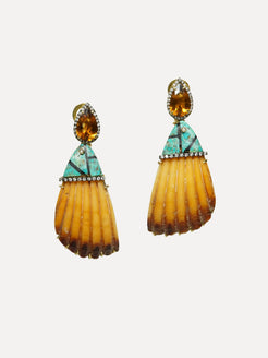 Pair of earrings with yellow and green gemstones on a white background