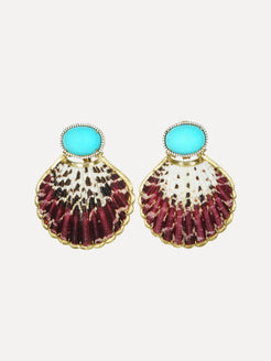 Pair of earrings with shell design and turquoise stones on a light gray background