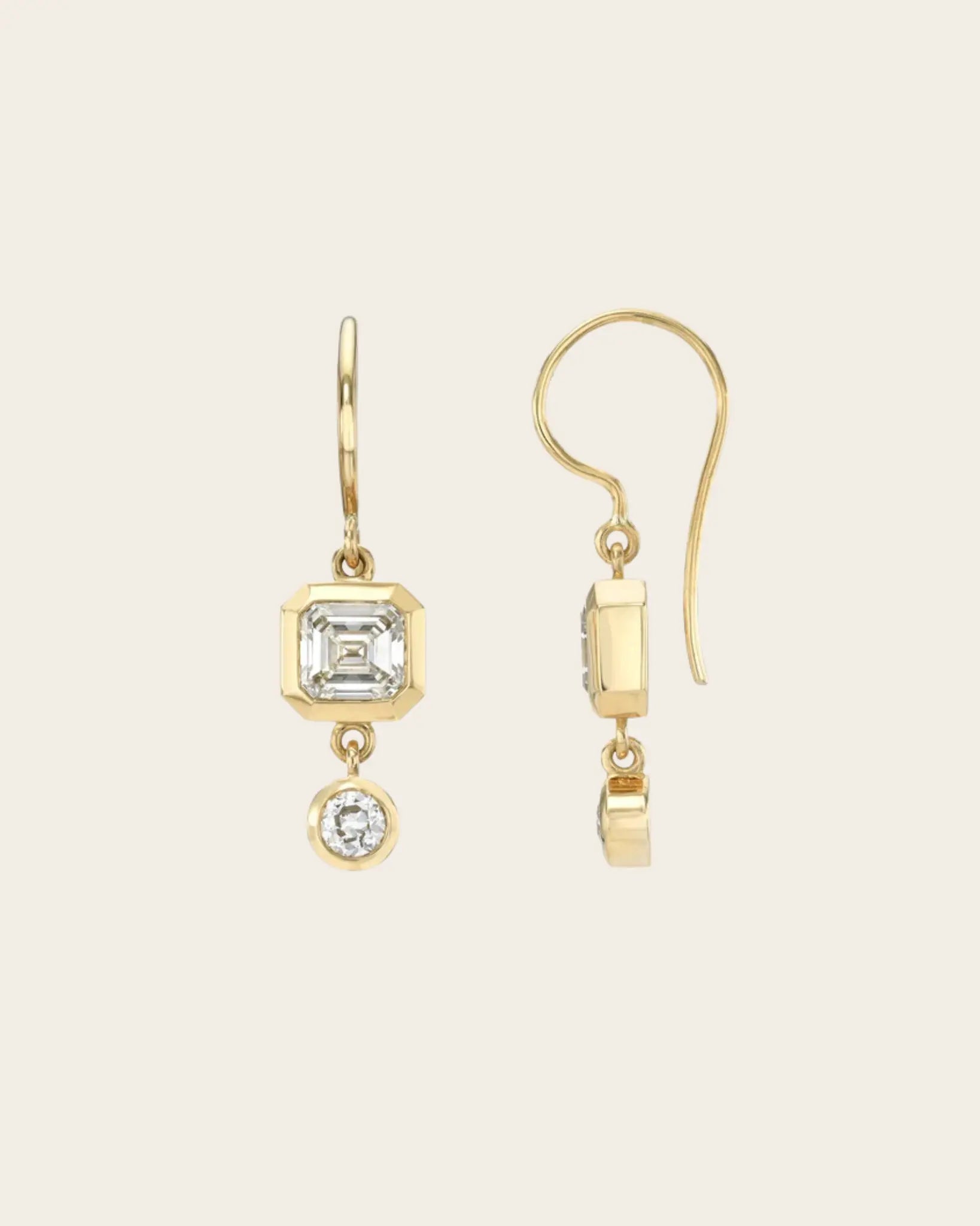 A pair if fish hook Single Stone gold diamond drop earrings.