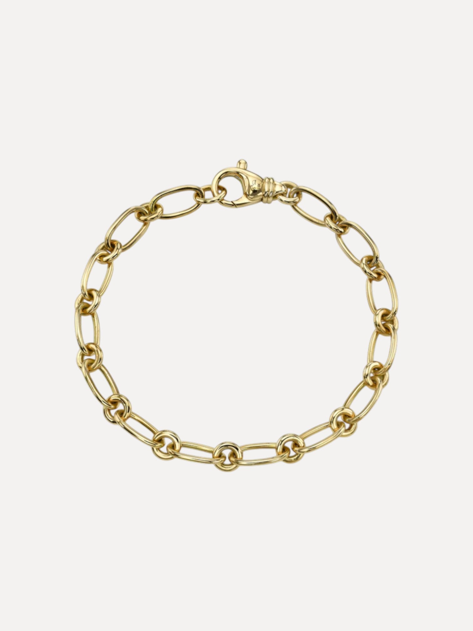 Gold chain bracelet on a light beige background. Handmade in LA and designed by Single Stone