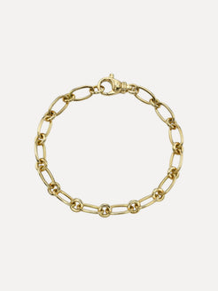 Gold chain bracelet on a light beige background. Handmade in LA and designed by Single Stone