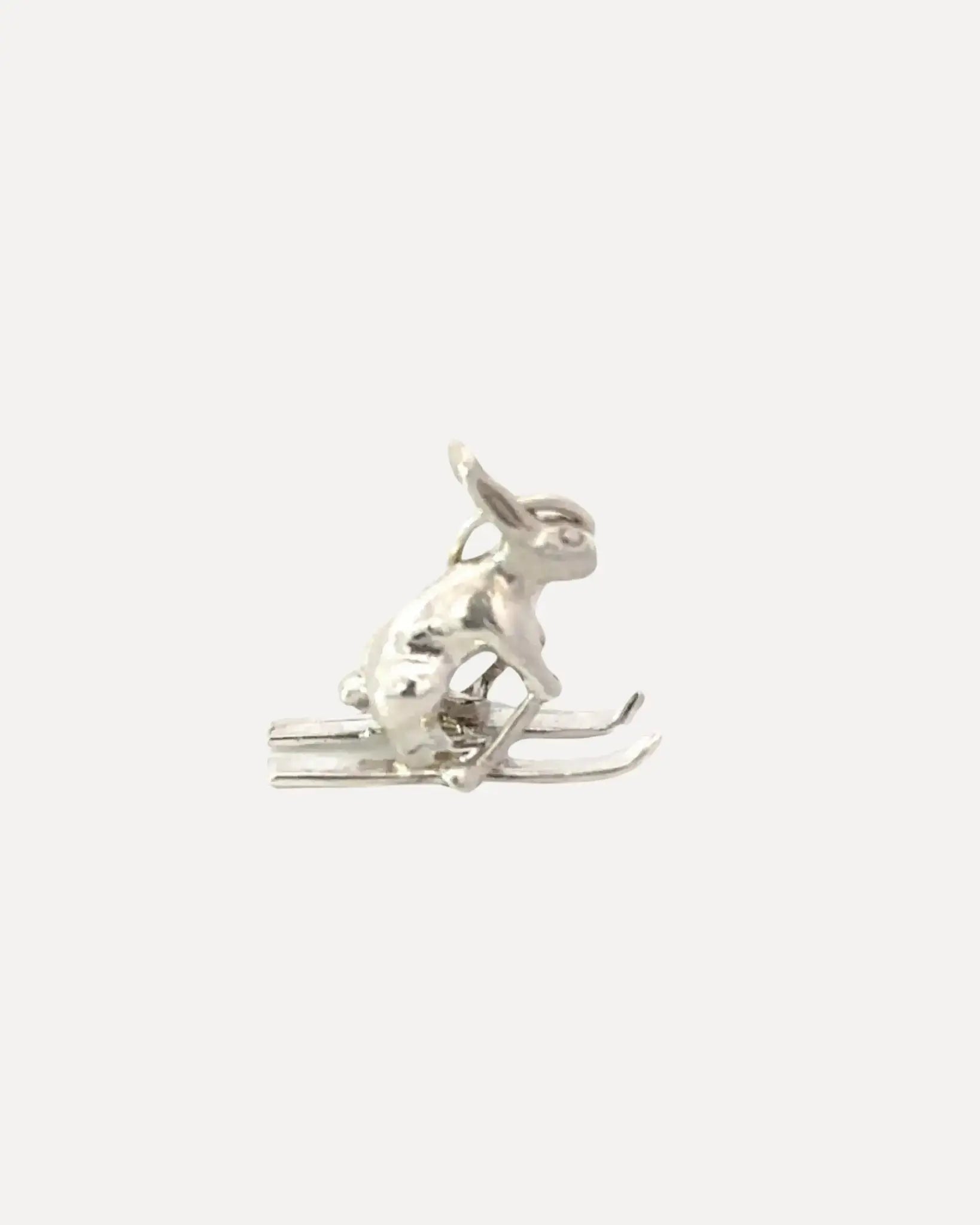 A sterling silver ski bunny charm by Squash Blossom.