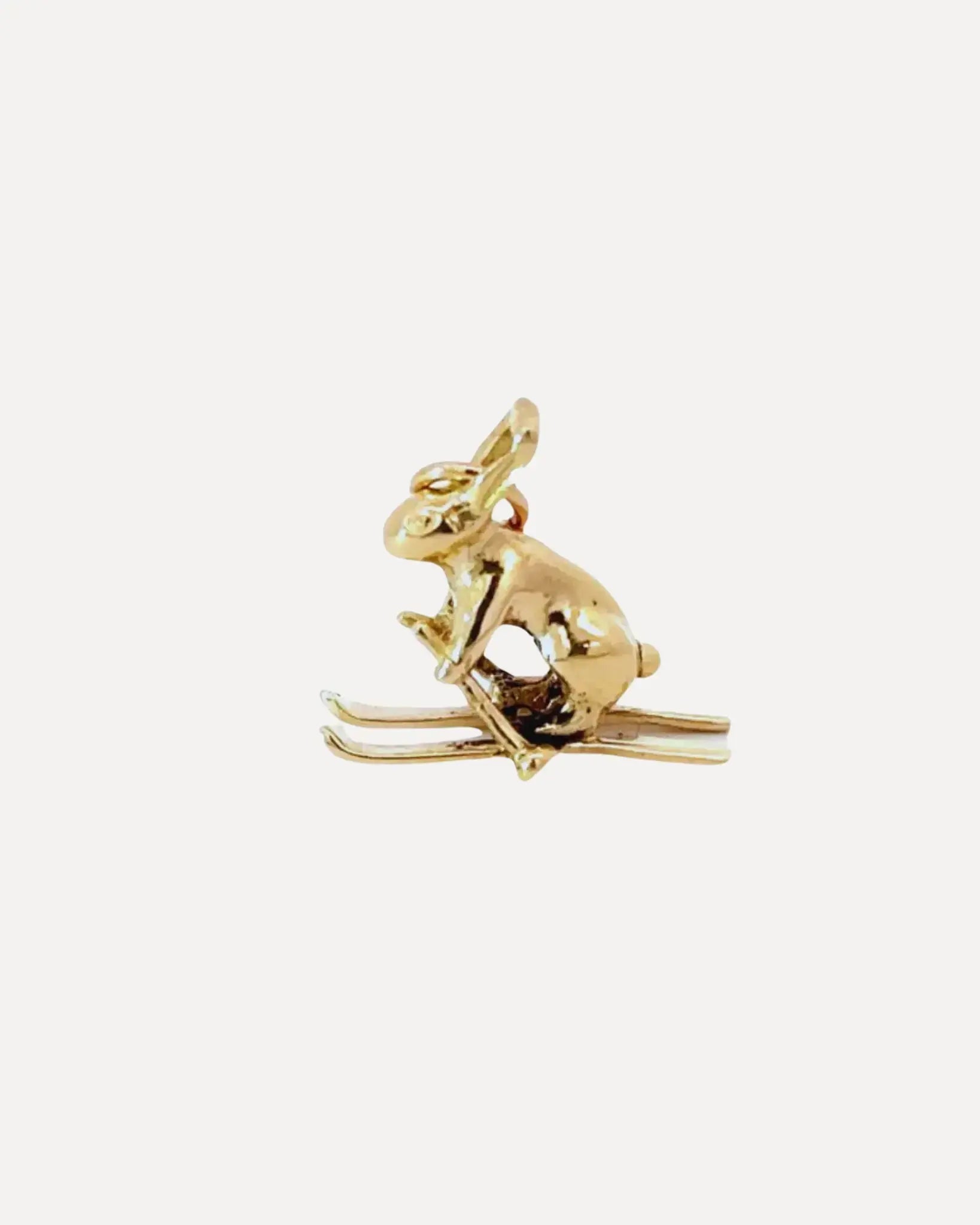 A bunny on skis gold charm by Squash Blossom