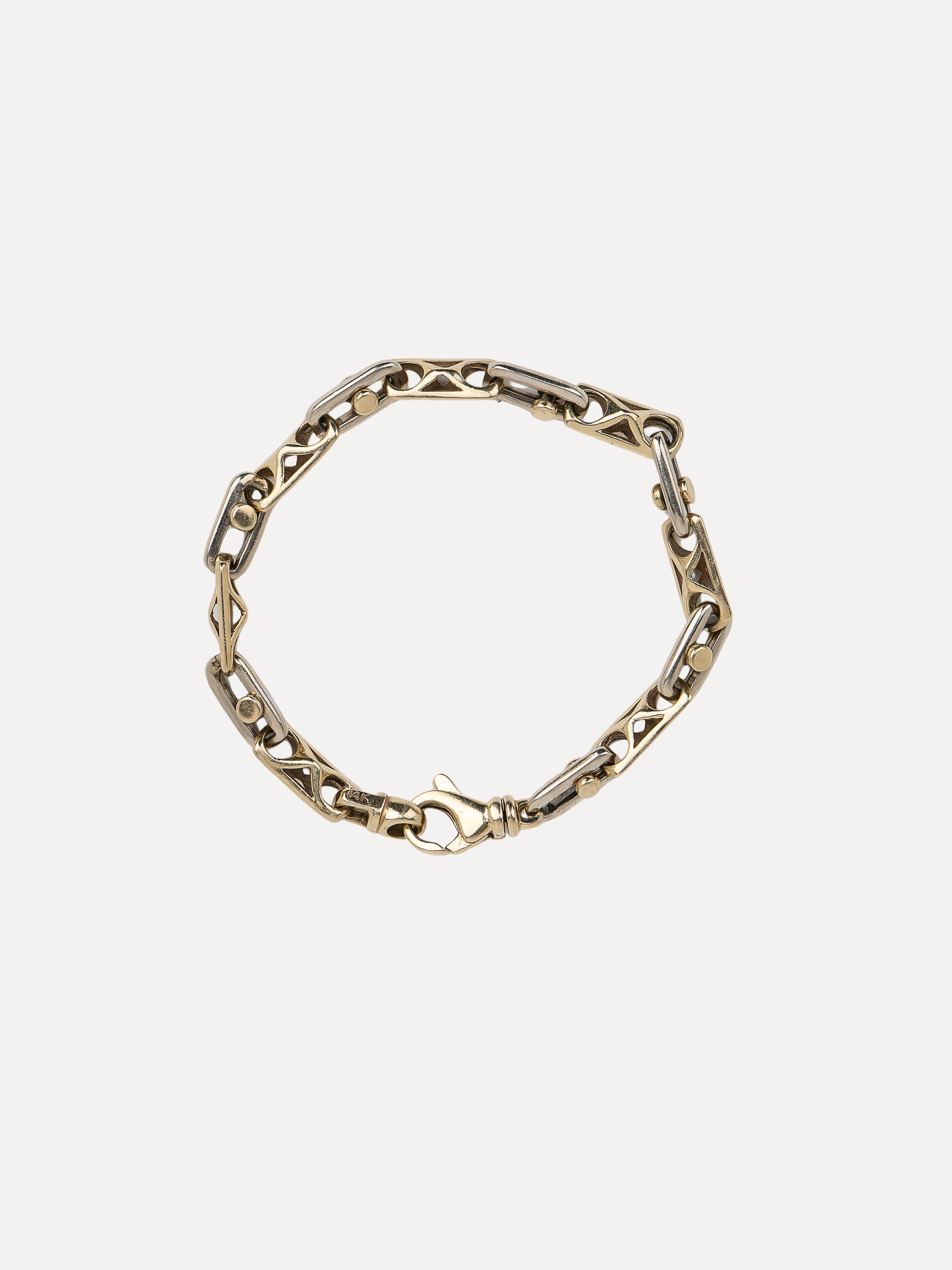 A gold-toned chain link bracelet with a unique textured, elongated link design and a spring-ring clasp, shown on a light gray background.
