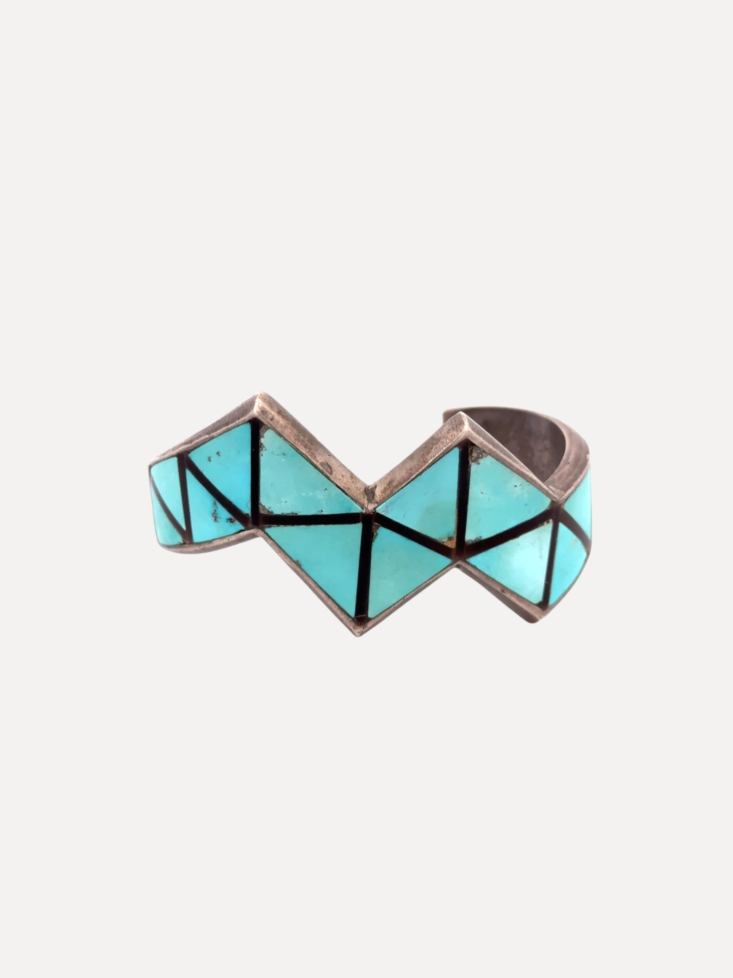 Geometric ring with turquoise and black design on a white background