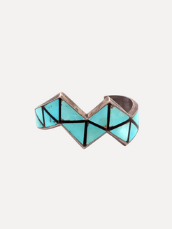 Geometric ring with turquoise and black design on a white background