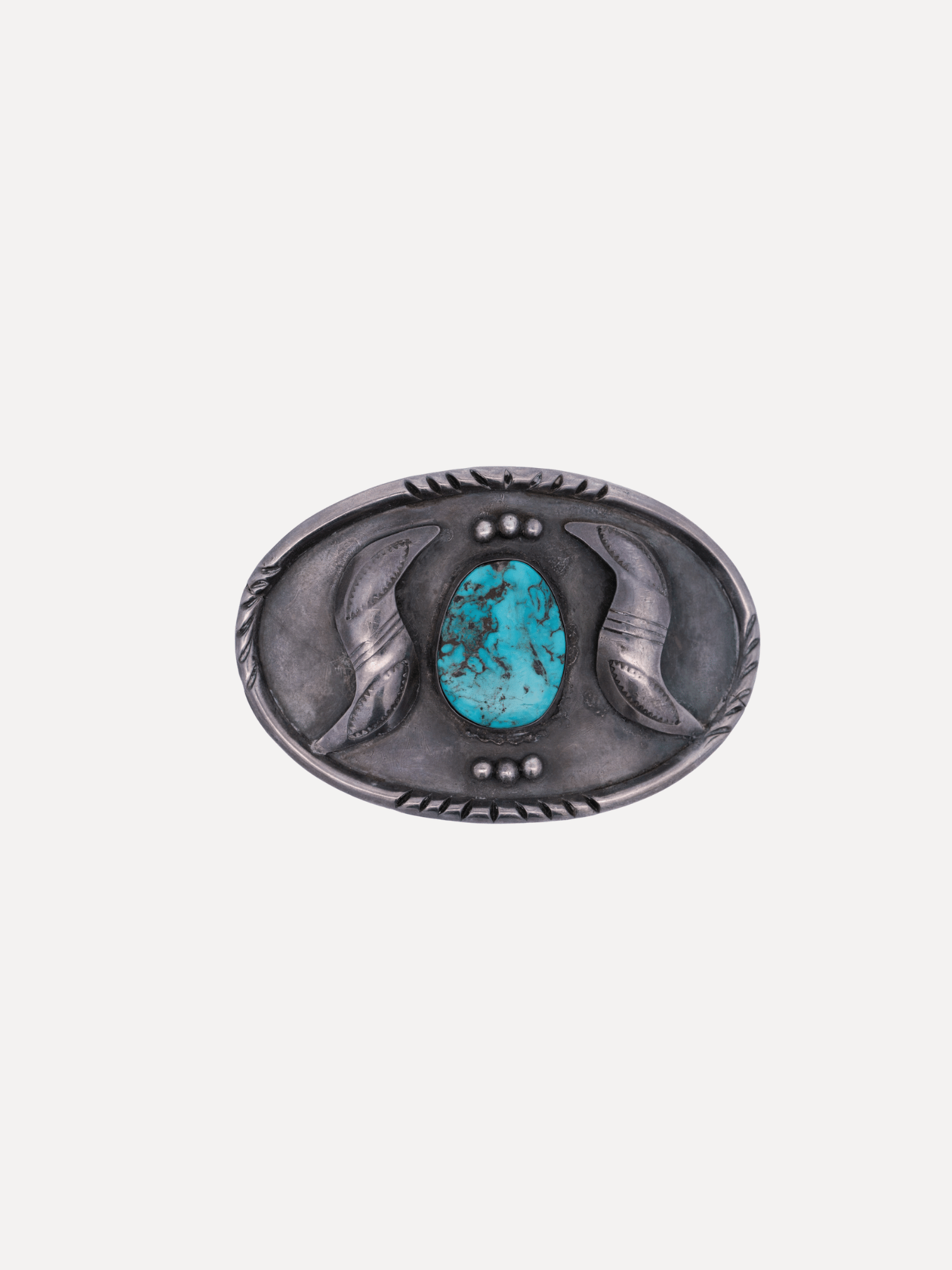 Silver belt buckle with a turquoise stone on a white background